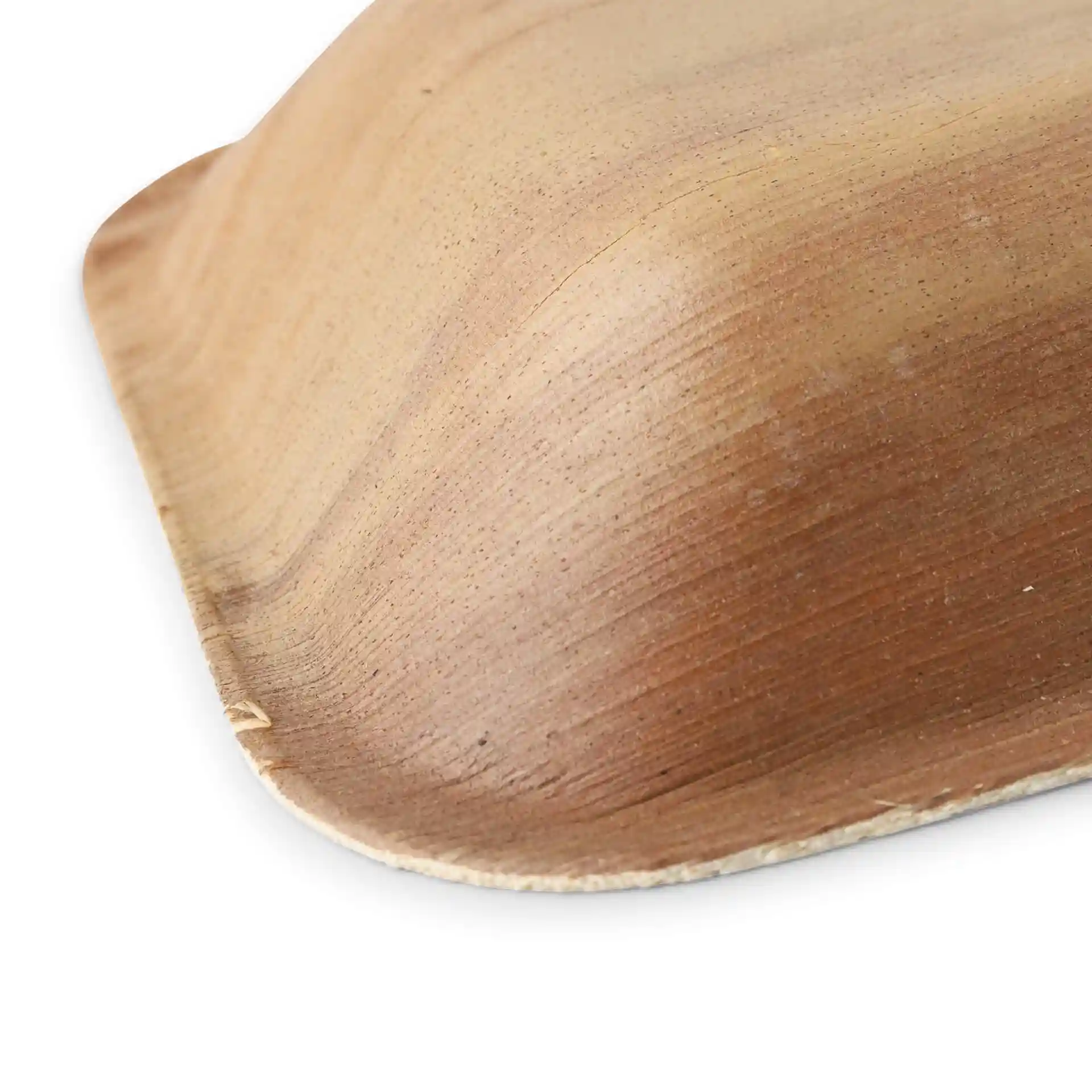 Close-up of a deep rectangular palm leaf plate with a natural grain texture.