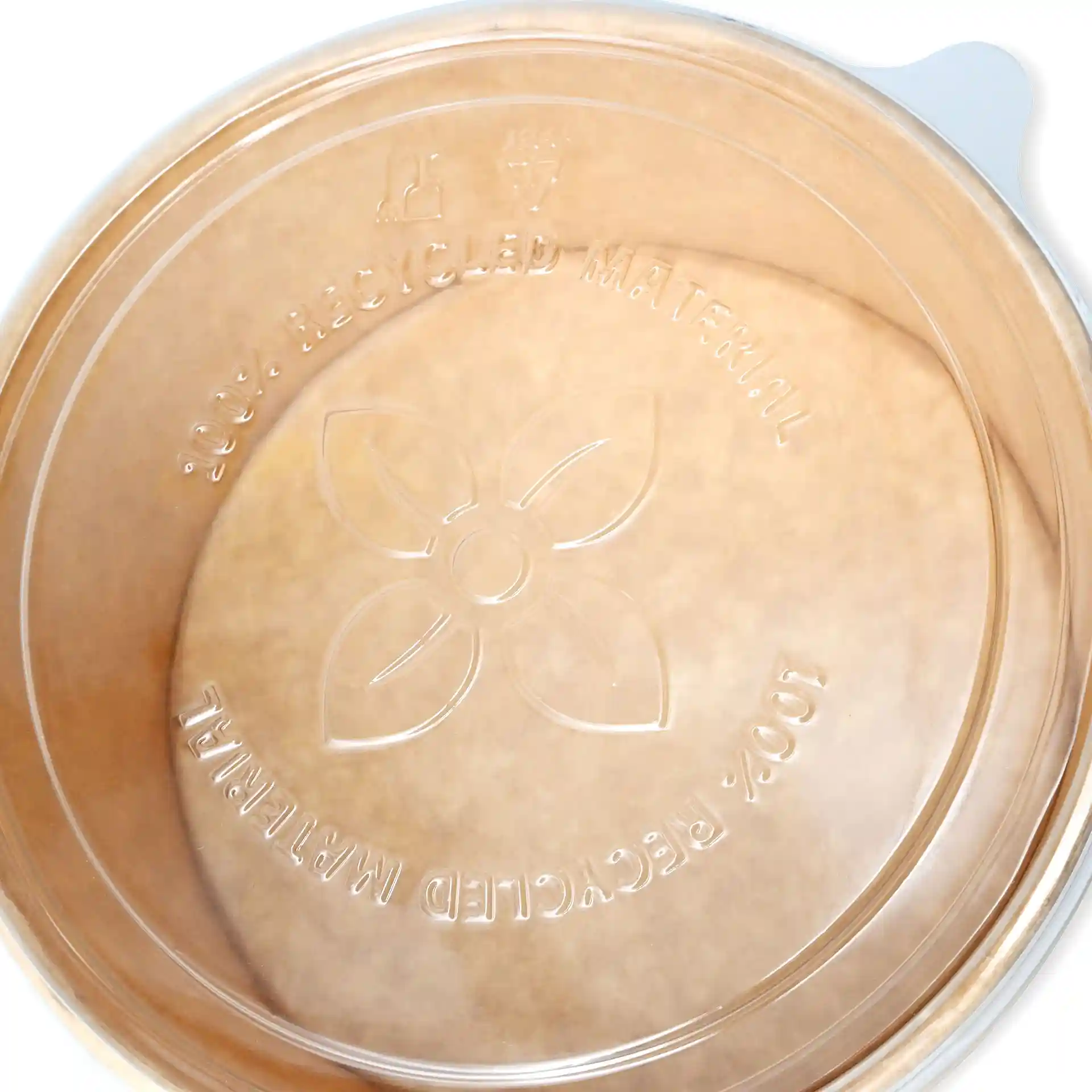 Transparent round cup lid made of rPET, showing a floral design and markings on the inner surface.