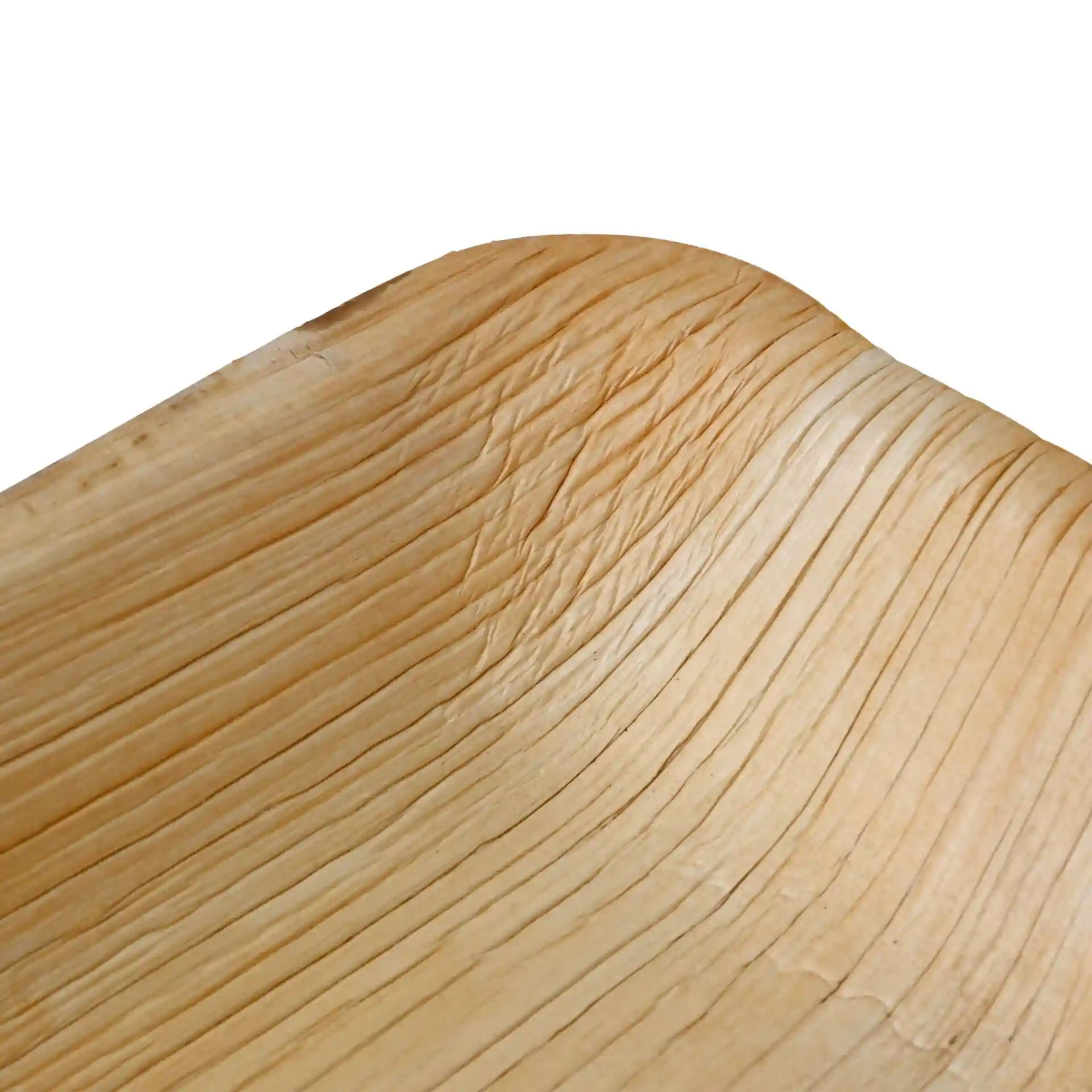 Close-up of a deep rectangular palm leaf plate with visible grain texture and curved edge.