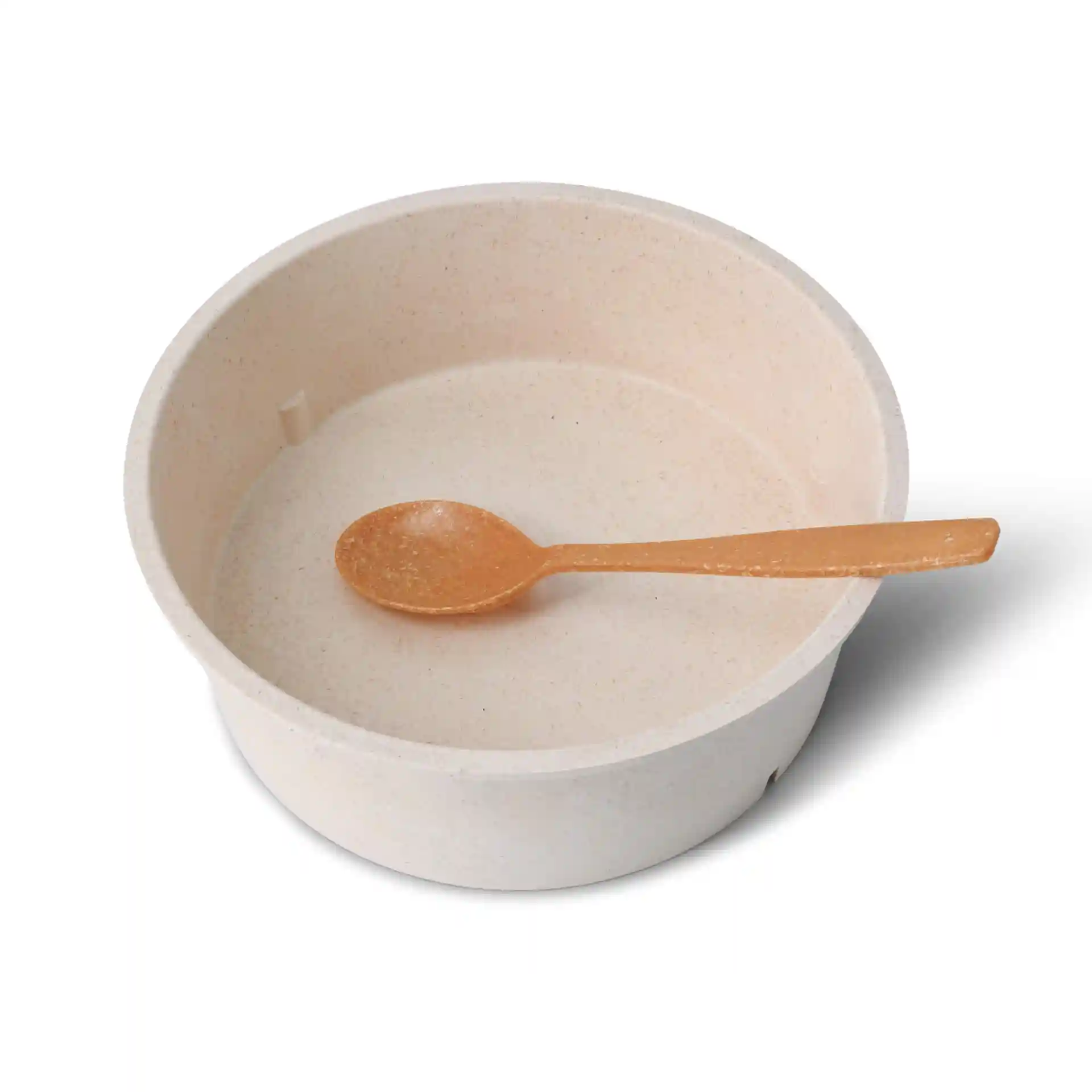 Round cream white reusable bowl with a small orange spoon inside, made from bio compound material.