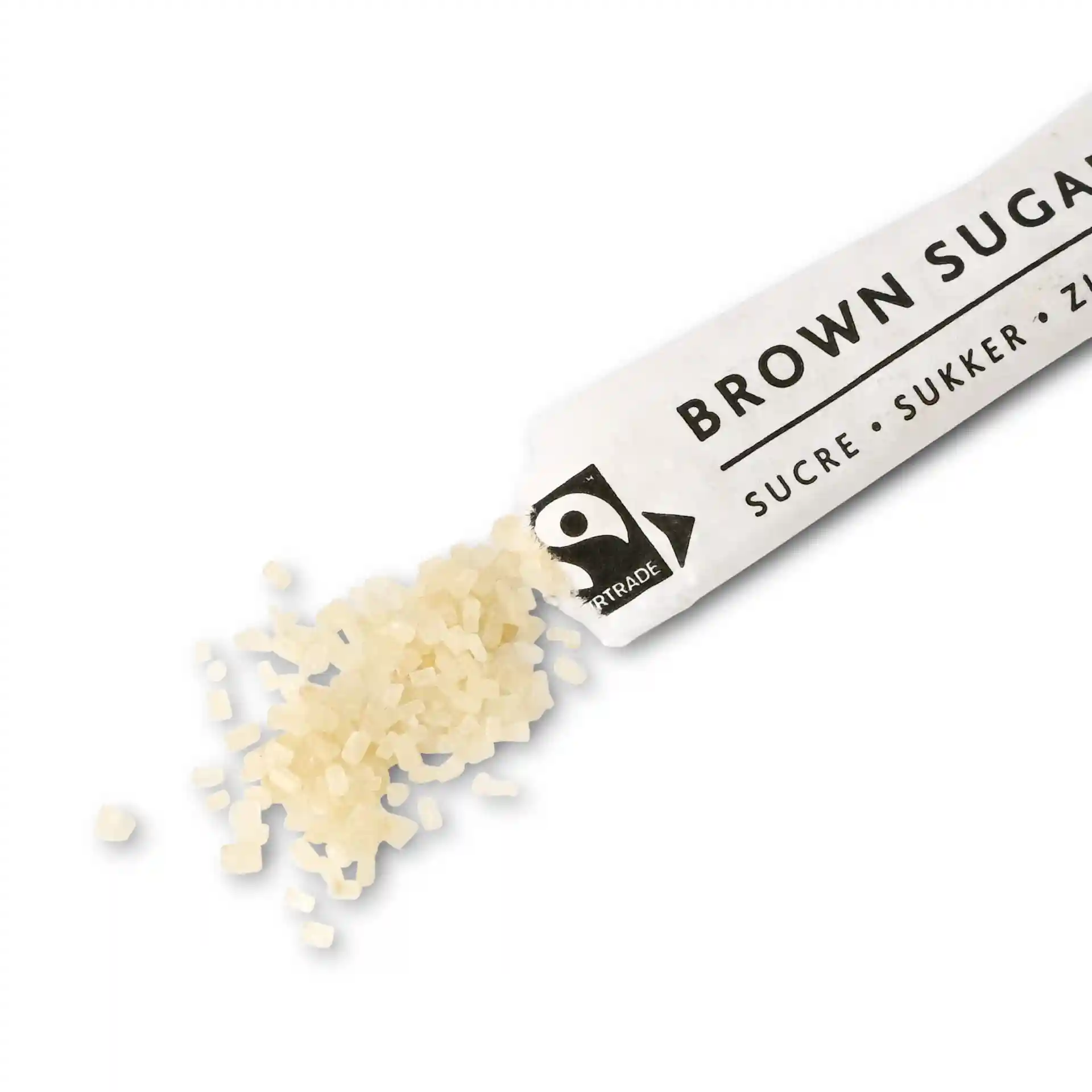 Brown sugar granules spilling from a white paper stick labeled "BROWN SUGAR" on a plain background.