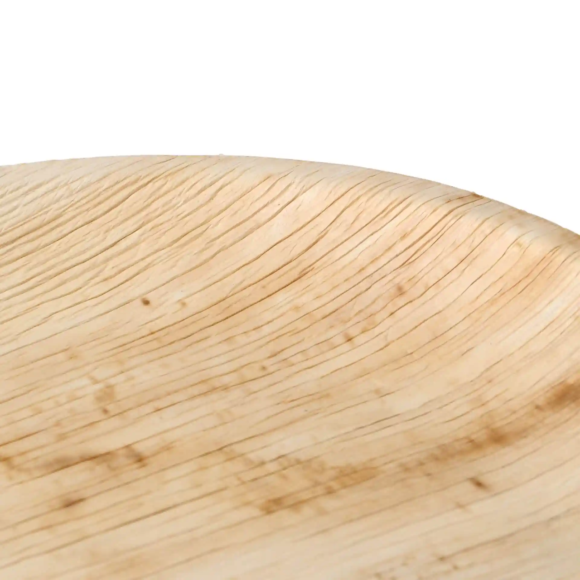 Close-up of a round palm leaf plate with visible grain texture, showing shallow depth and natural markings.