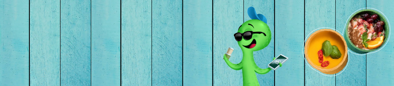 Green cartoon character wearing sunglasses, holding a drink and a phone, with bowls of food displayed on a blue wooden background.