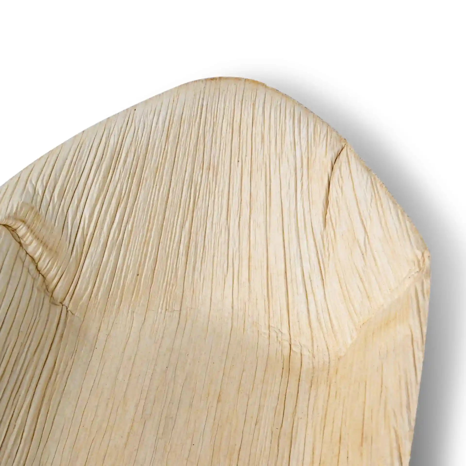 Close-up of a palm leaf boat with a textured surface, showing the natural grain and shape.