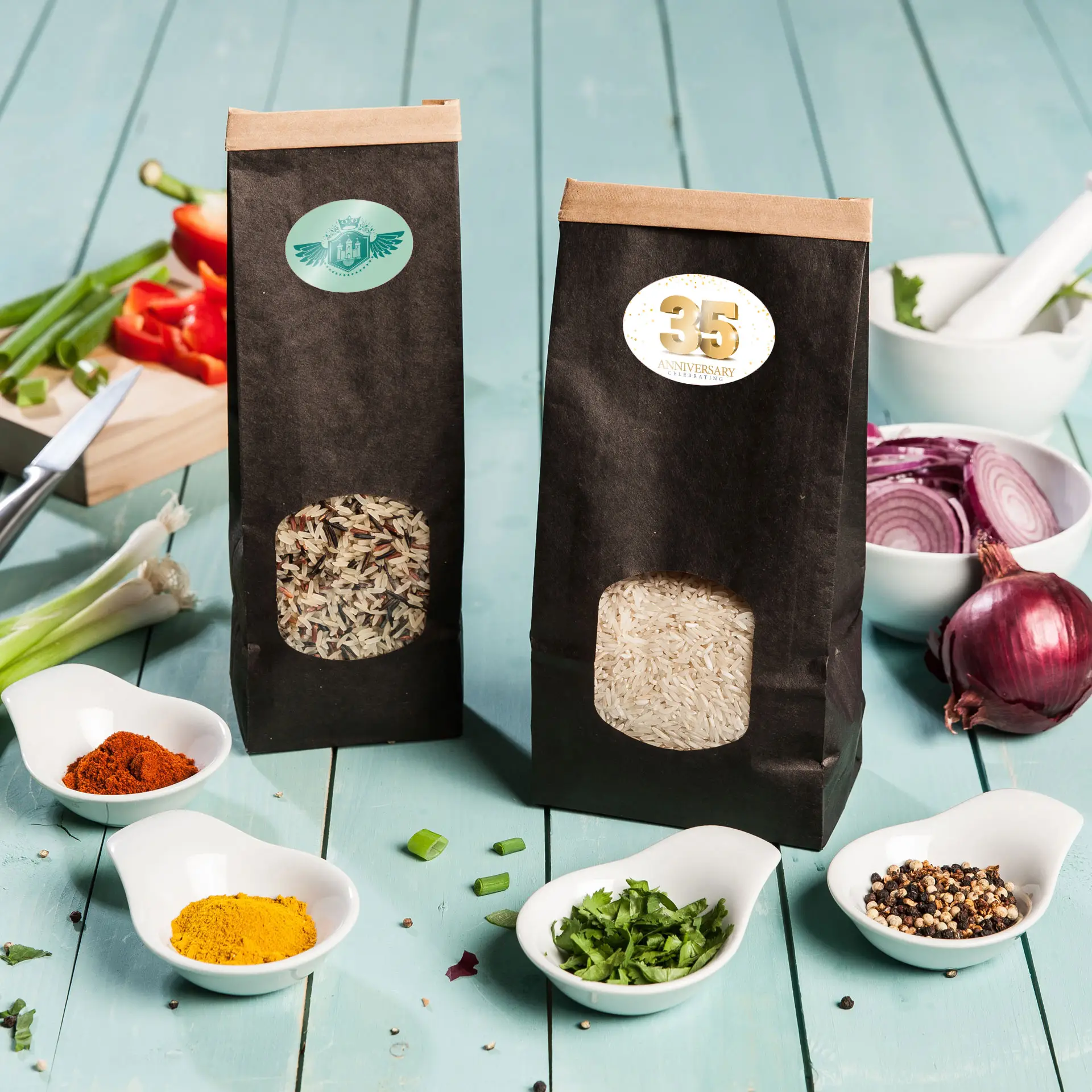 Two black packaging bags of rice, one containing white rice and the other wild rice, with surrounding spices in white dishes.