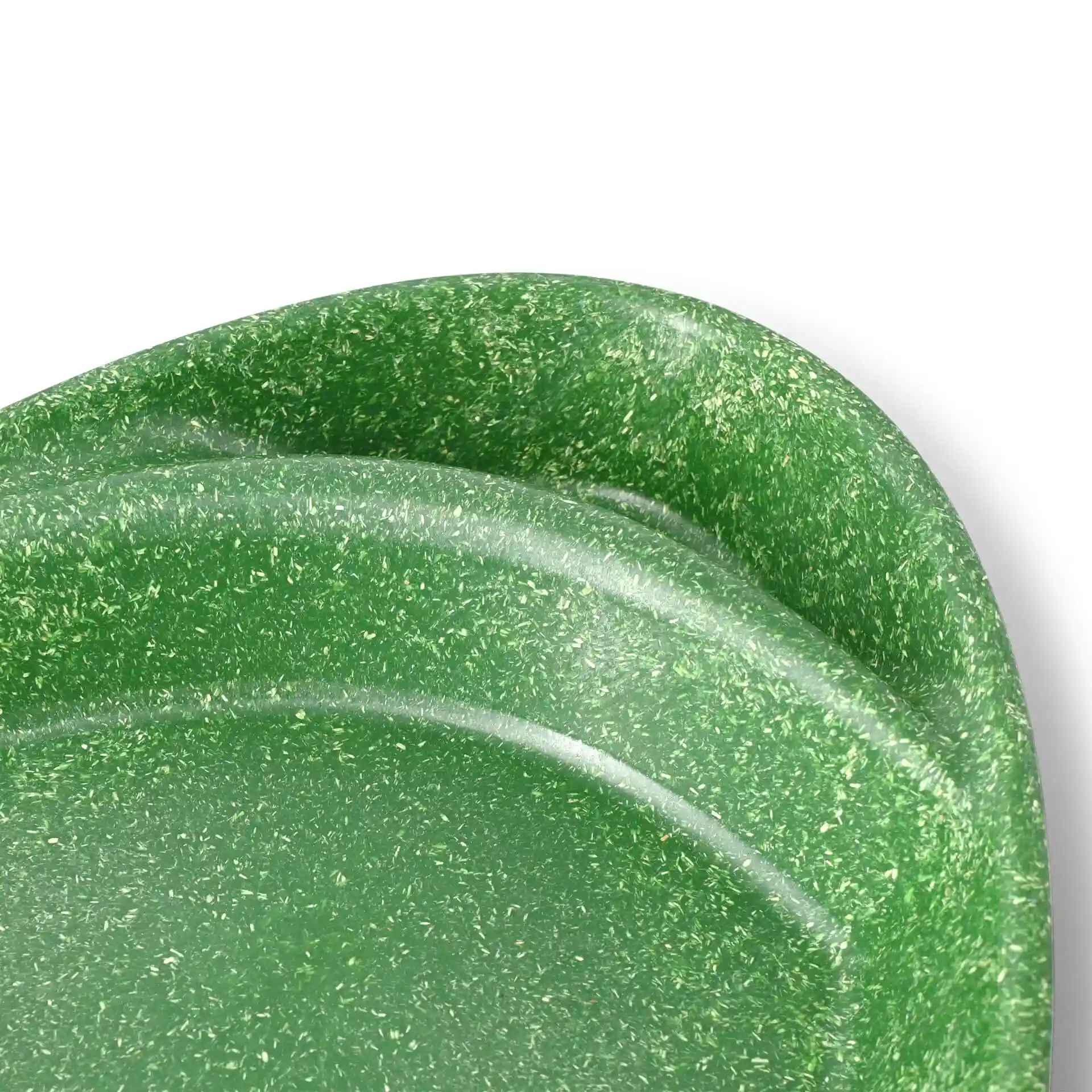Dark green reusable divided plate with two compartments, teardrop shape, showing a textured surface.
