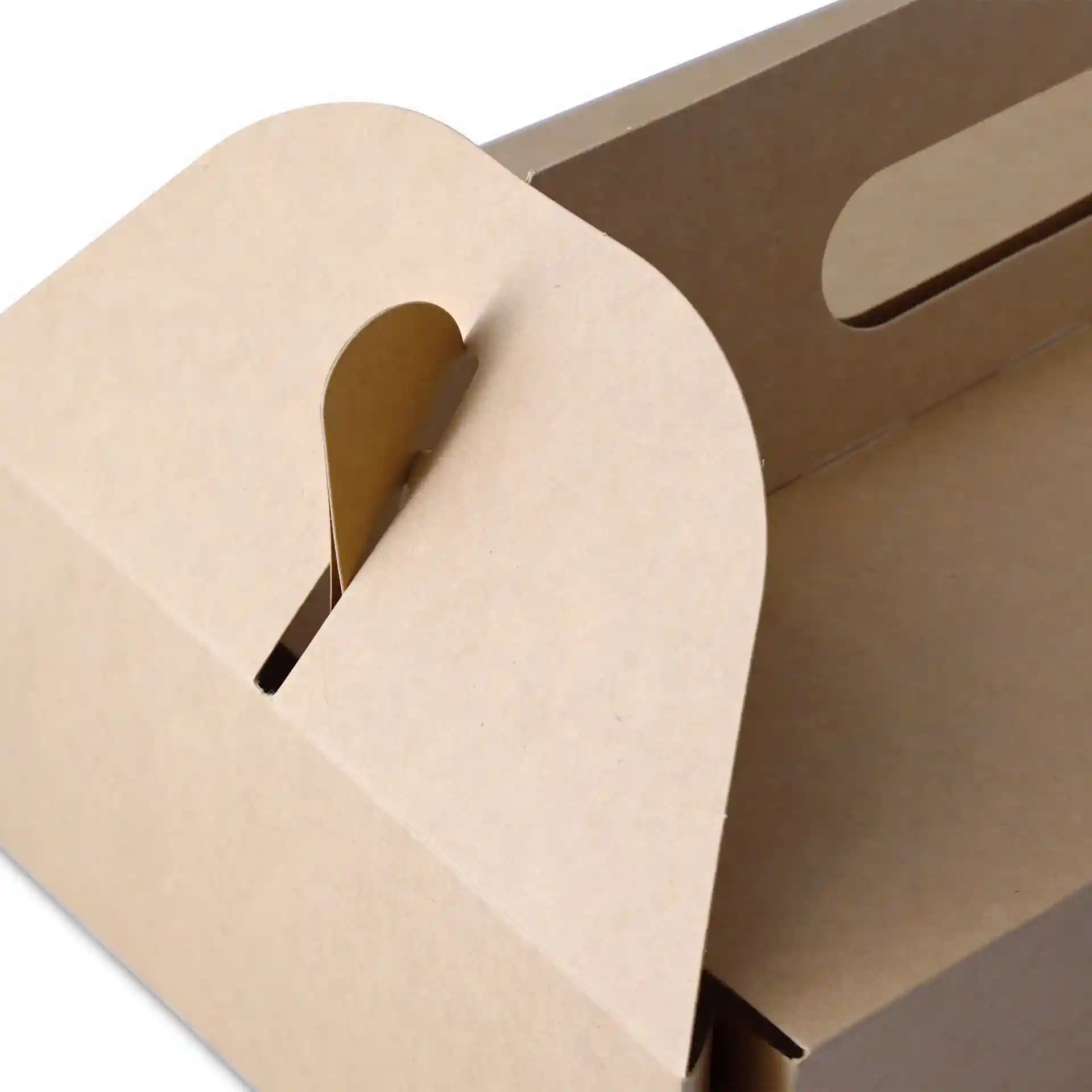 Brown cardboard pastry box with a handle, showing the top edge and slot for closure.