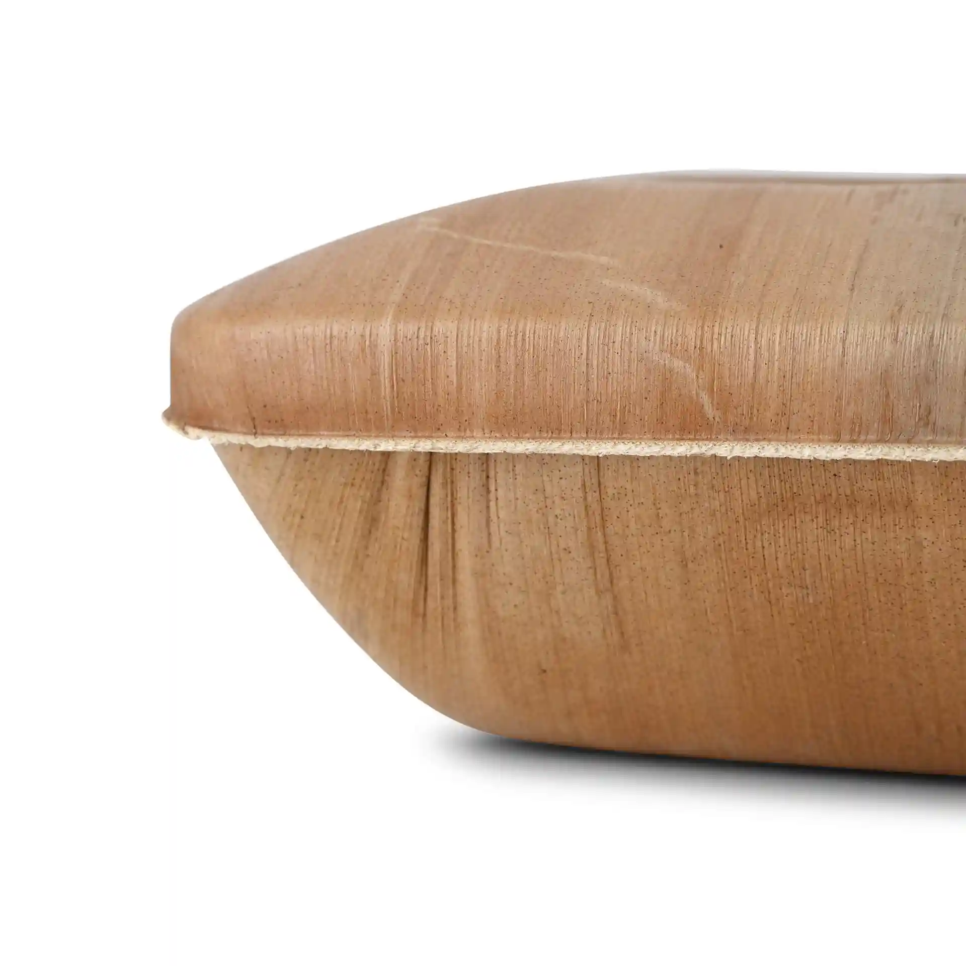 Close-up view of a square palm leaf bowl with a smooth, grainy texture and a lid, showing the edge and surface details.