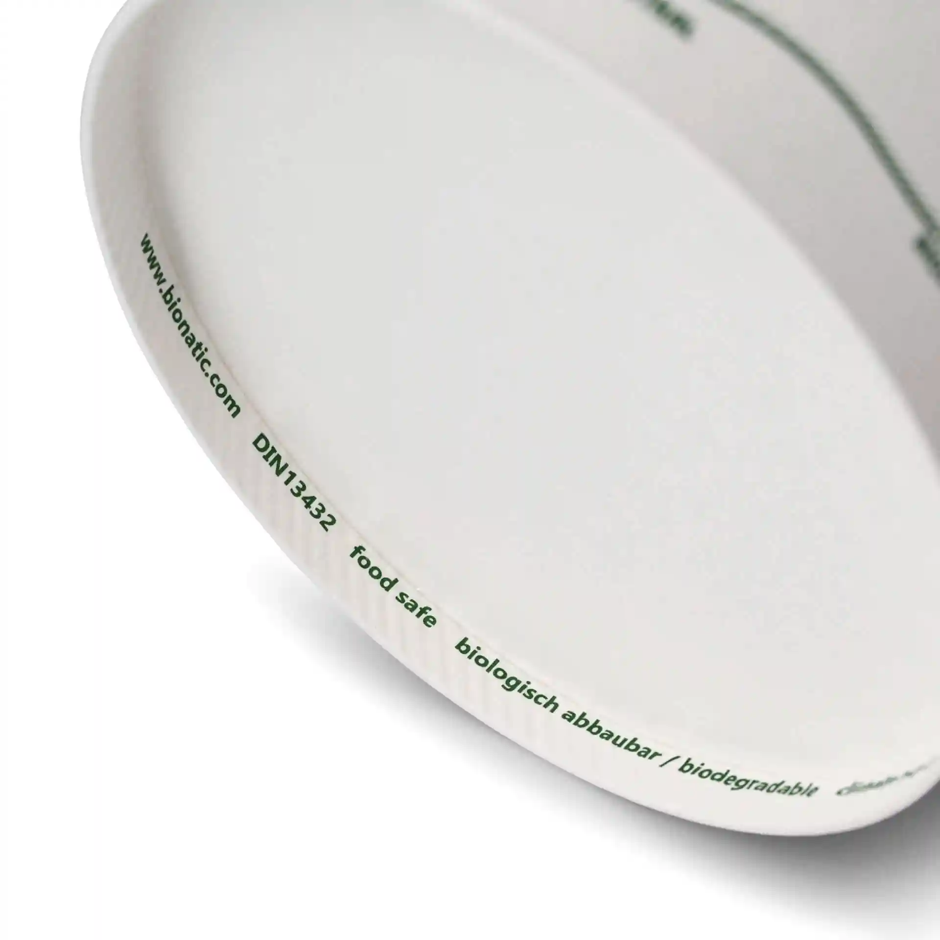 Round cardboard soup container with printed markings, showing the inner rim and part of the exterior.