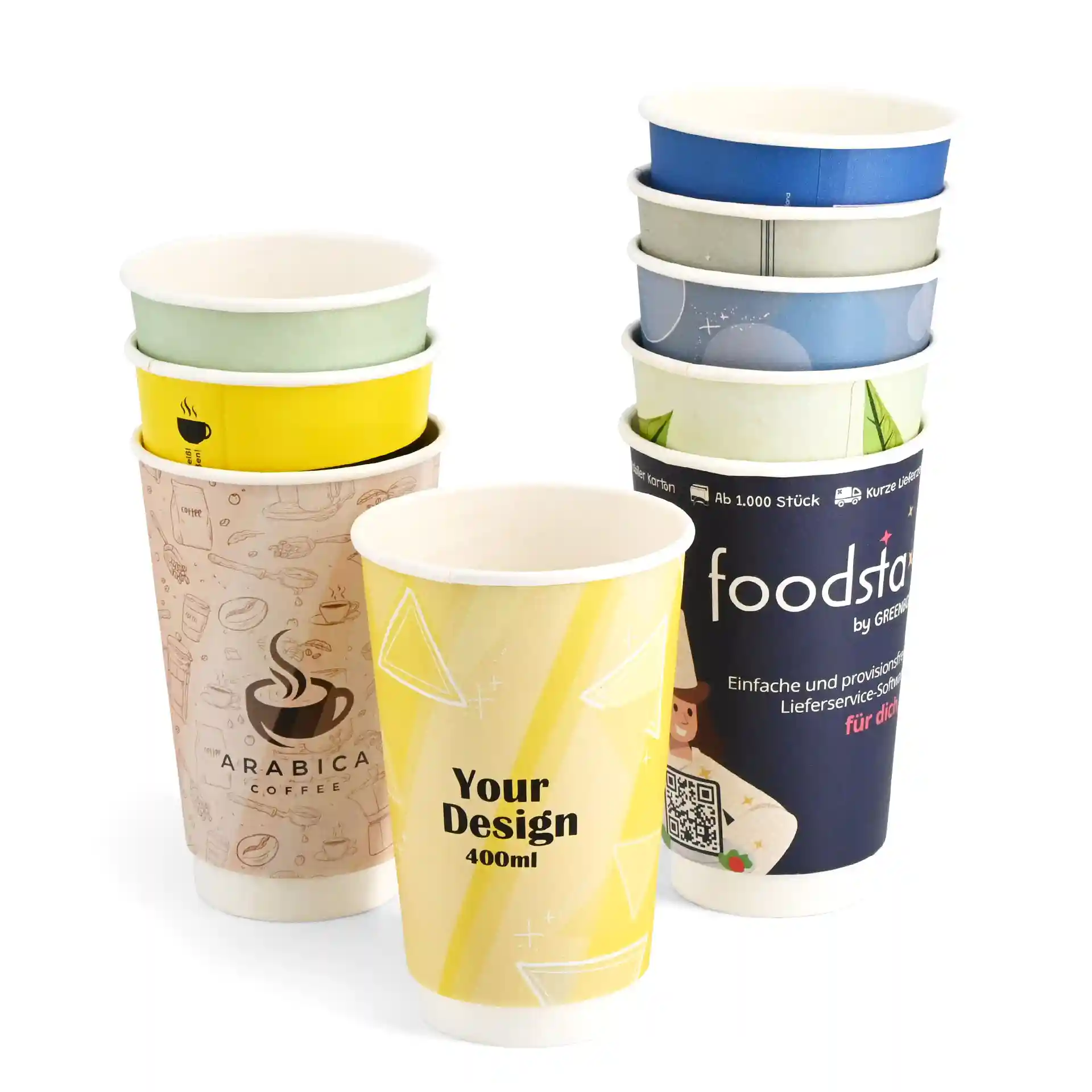 Stack of custom printed paper cups in various designs, showcasing a yellow cup with "Your Design" and a coffee-themed cup.