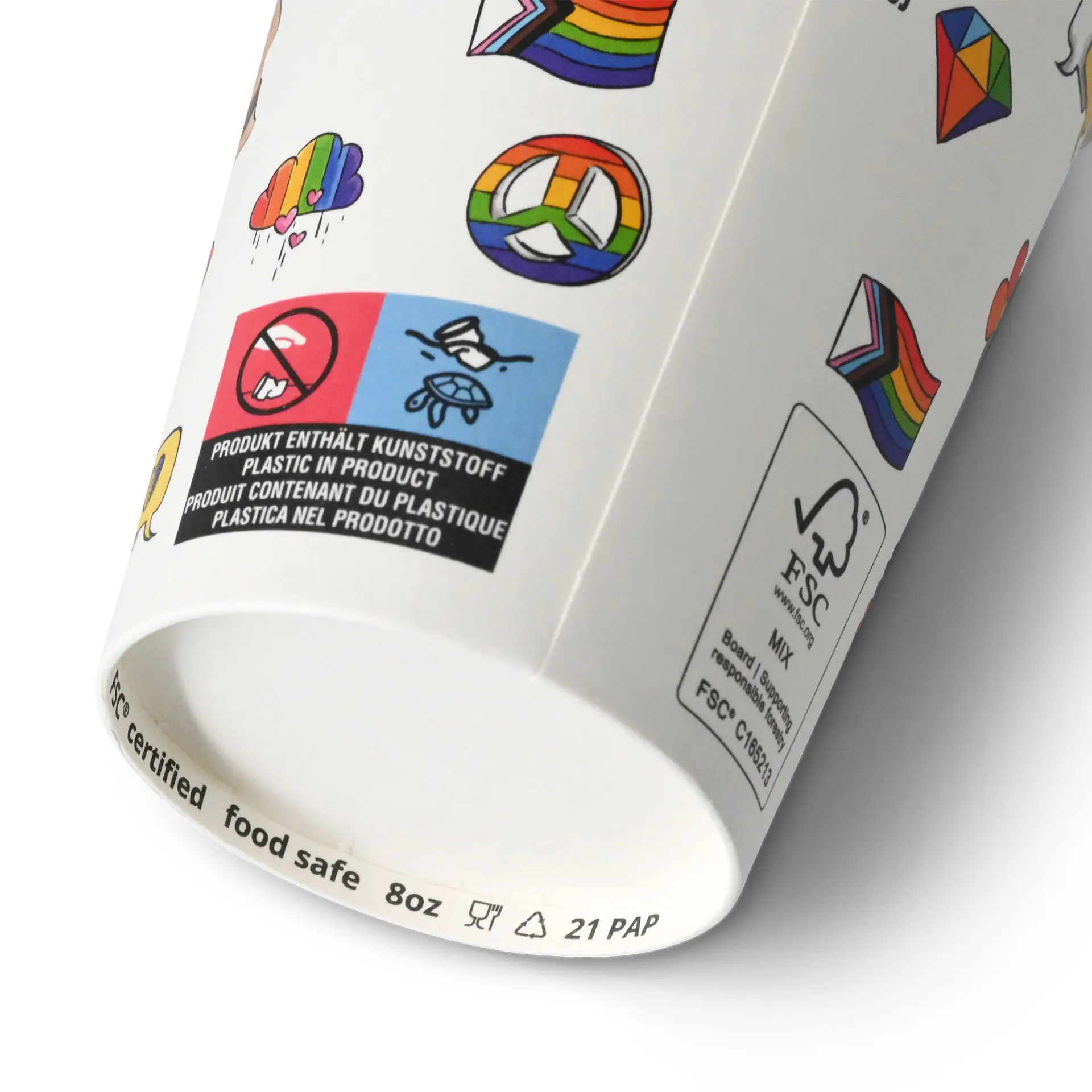 White paper cup with printed designs, including rainbows and symbols, featuring a blue label with icons and a certification mark.