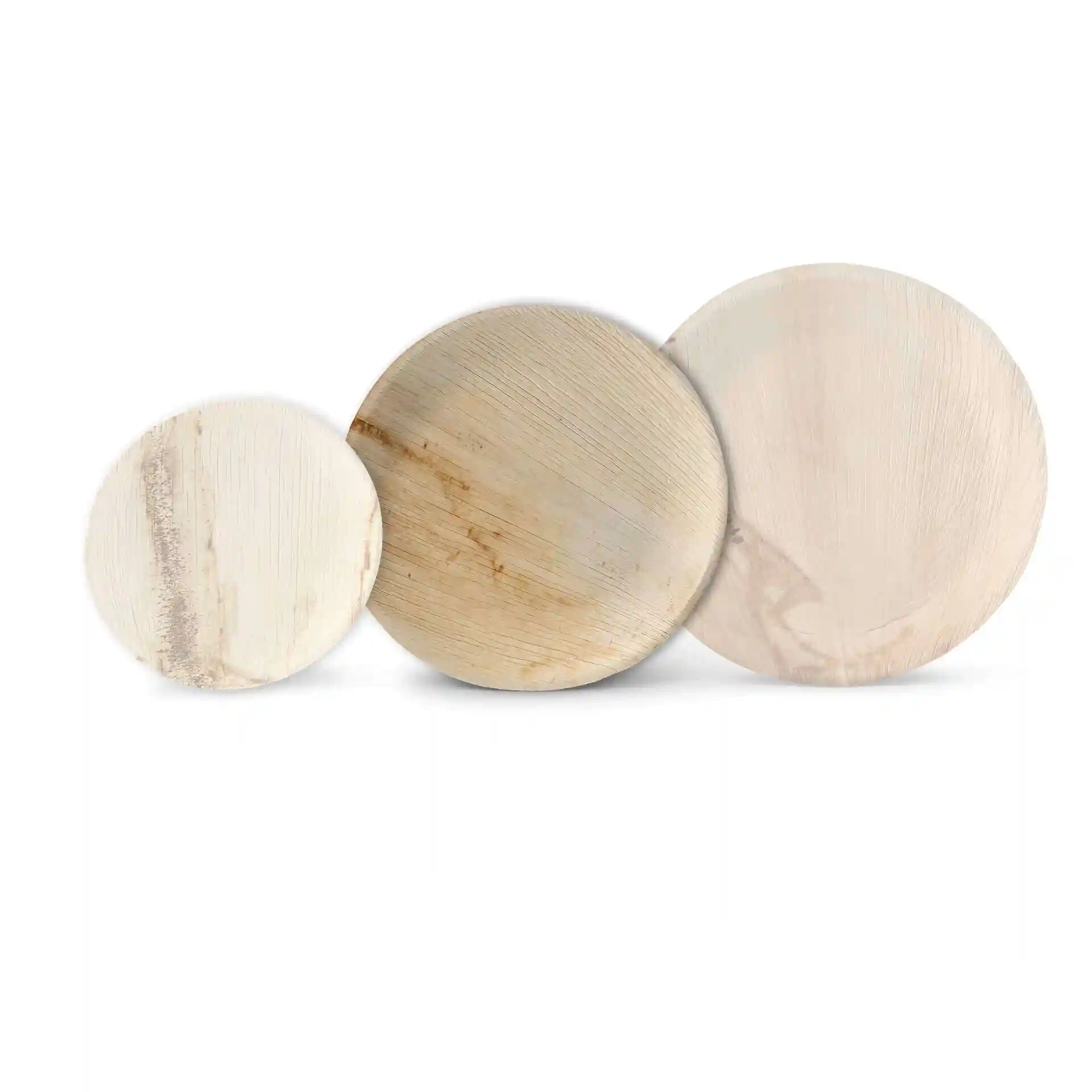Three round palm leaf plates in varying sizes, showcasing a natural grain pattern.