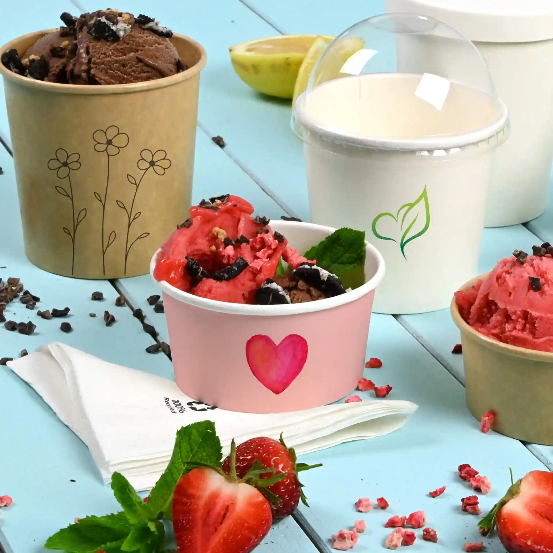 Image of three ice cream cups: a pink cup with a heart, a brown cup with flowers, and a white cup with a green leaf design.