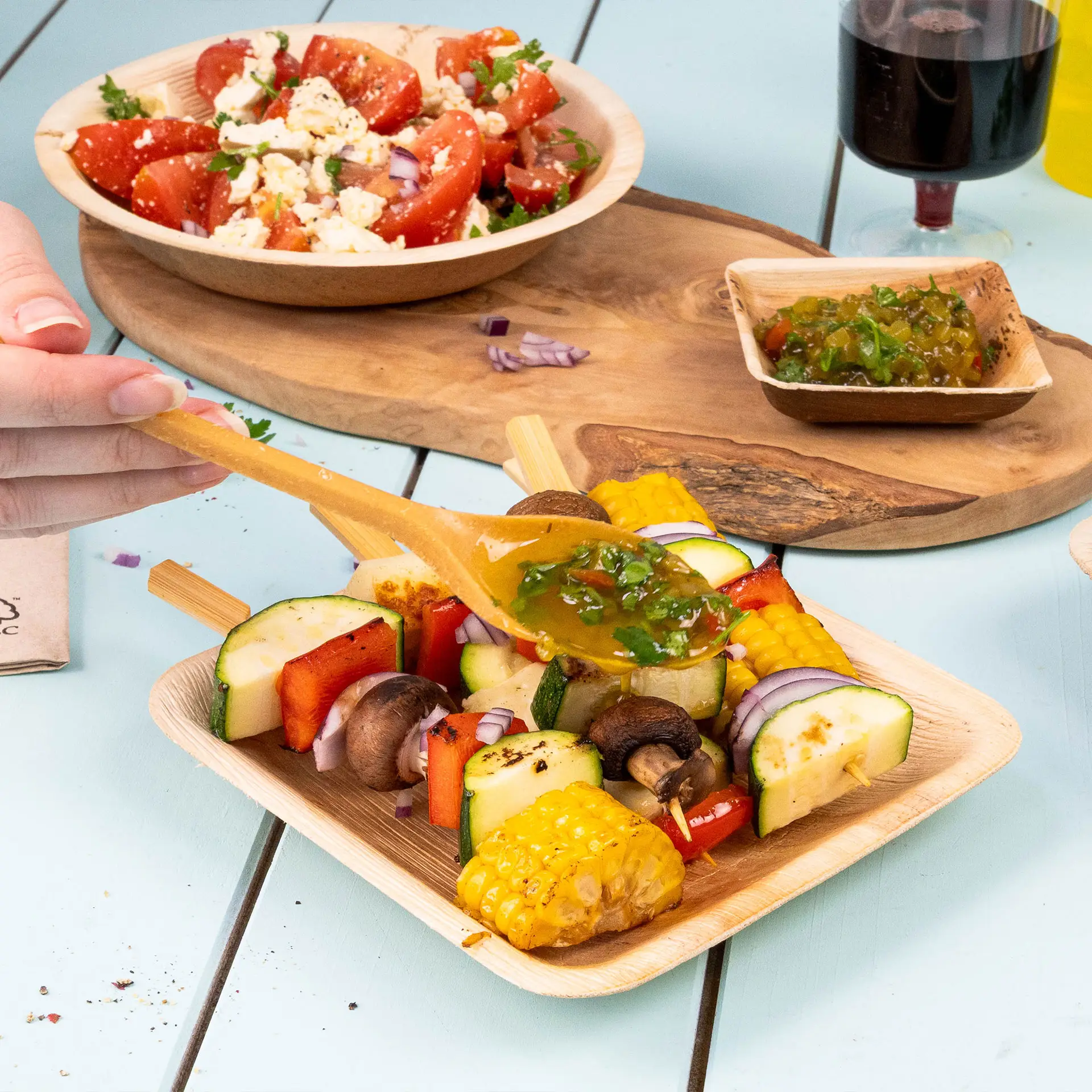 Square palm leaf plate, 15 x 15 cm, featuring small sauce rims and a natural grain texture. Lightweight and sturdy design.