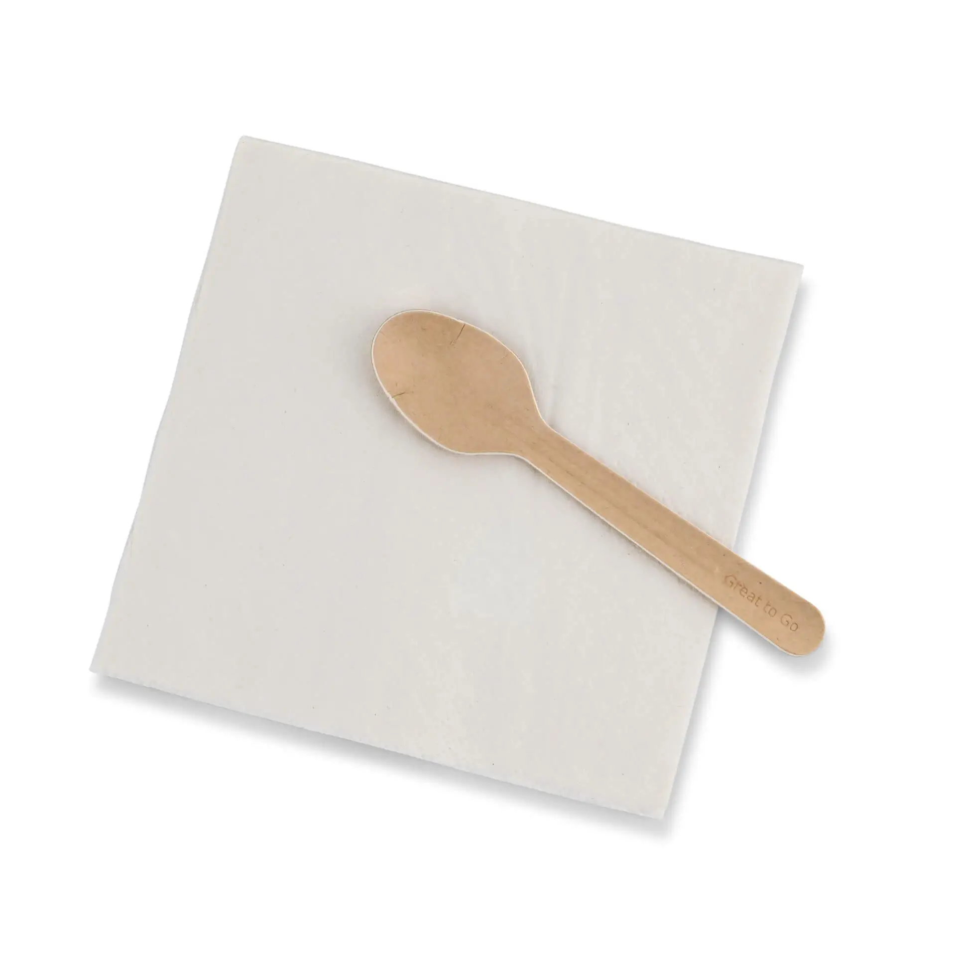 Brown paper spoon on a white napkin with a recycling symbol and text, placed on a plain background.