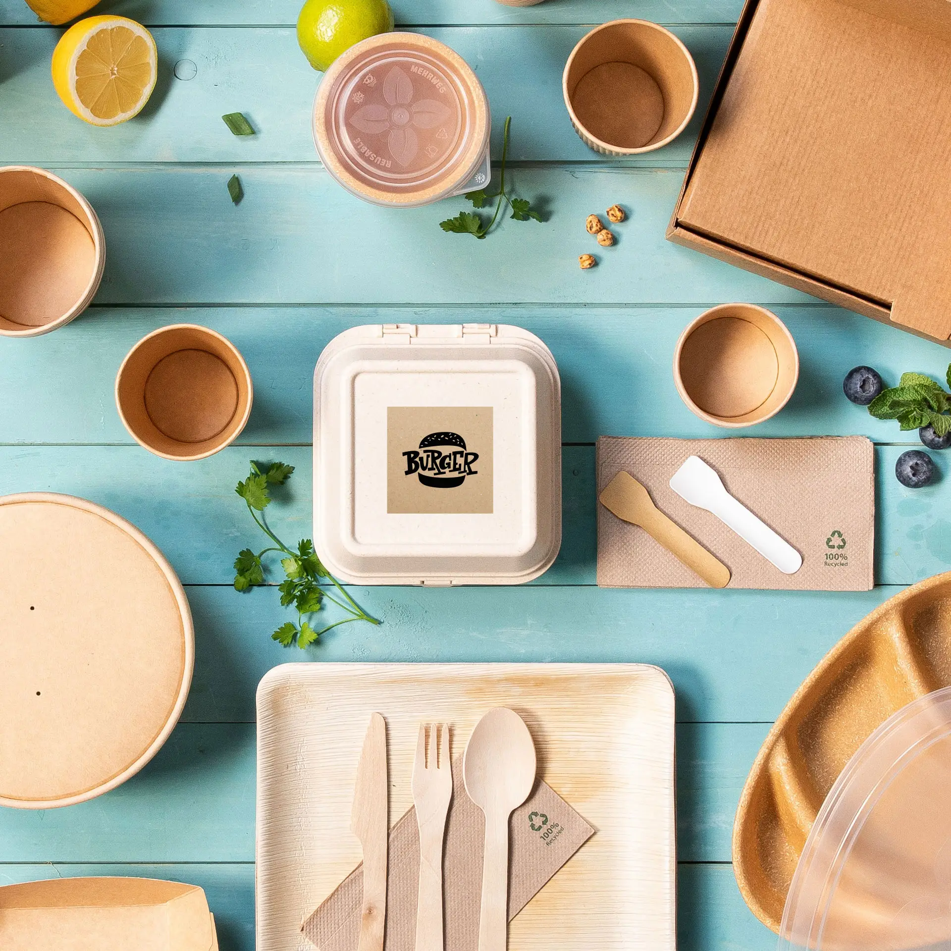 A square kraft paper container with a burger logo, surrounded by various disposable food packaging and utensils.