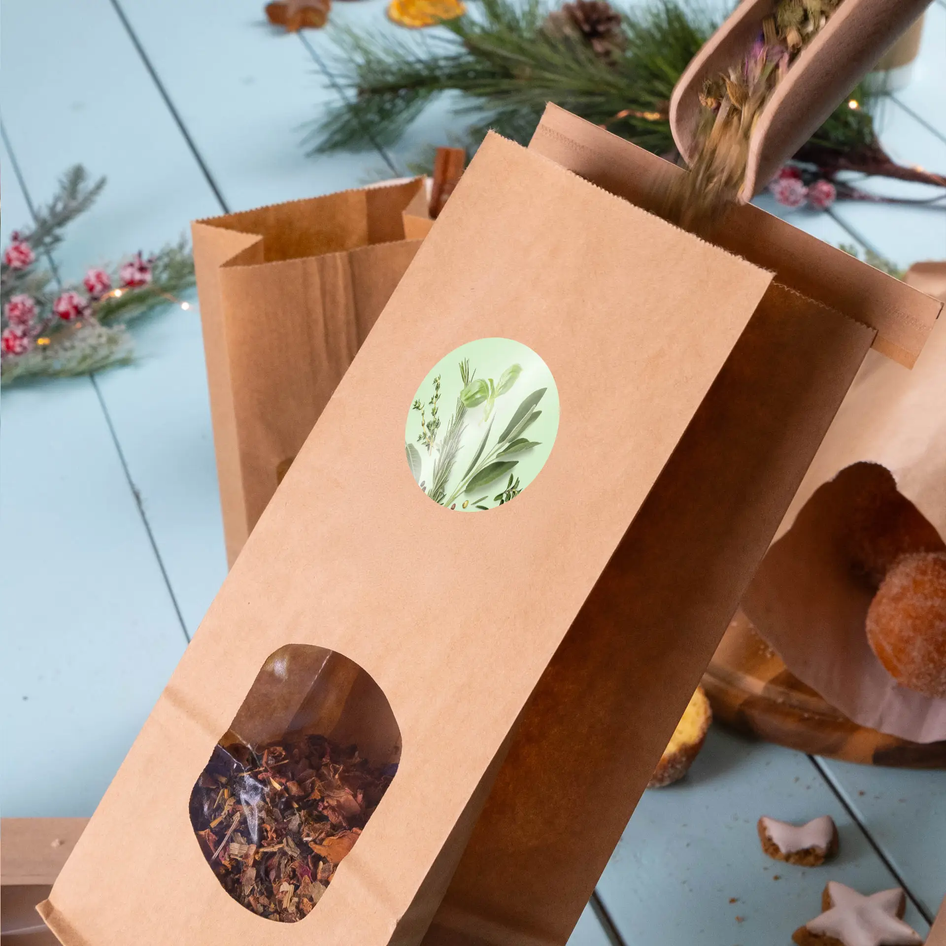 A brown kraft paper bag with a circular green label and a transparent window, filled with loose herbal tea ingredients.