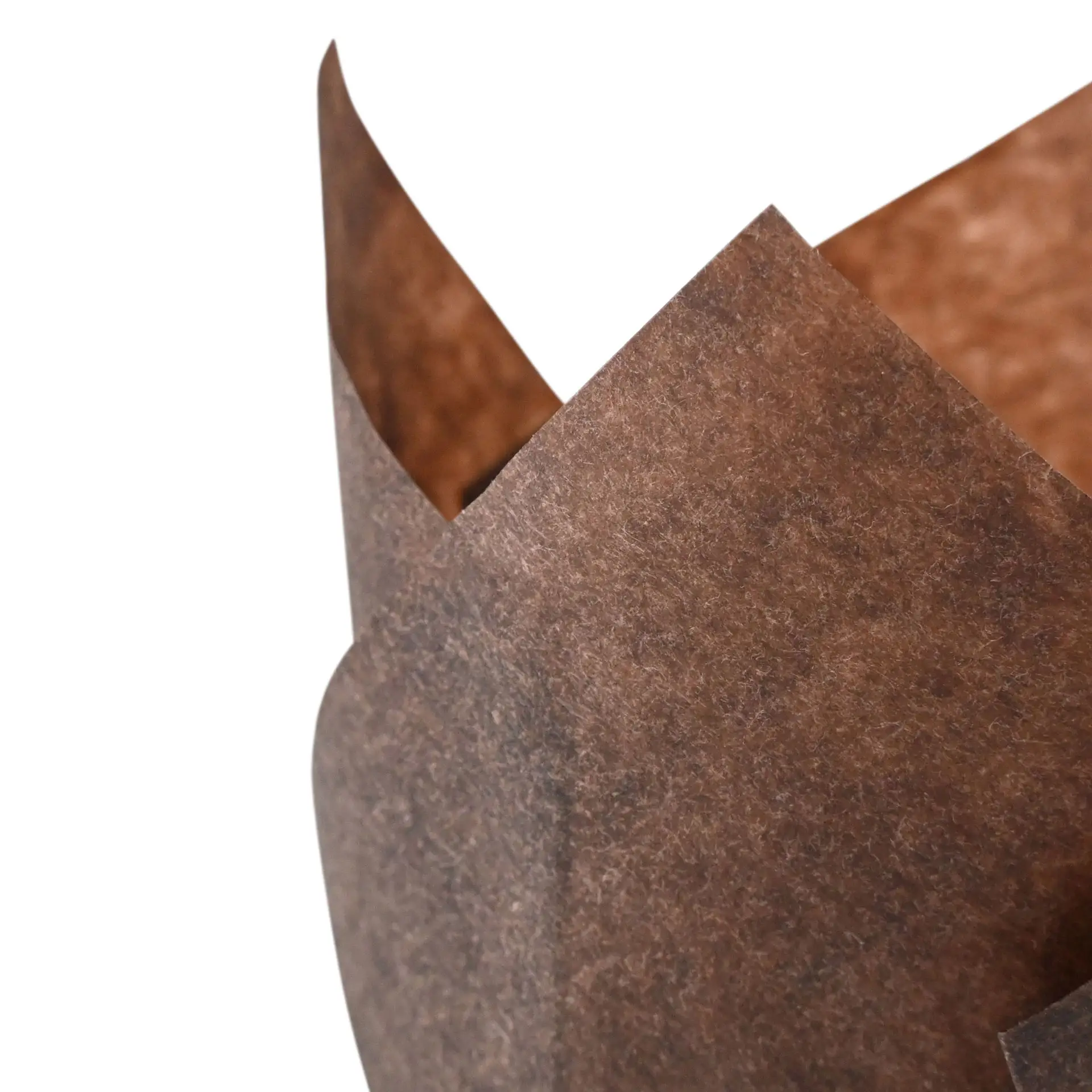 One brown greaseproof paper muffin cup, featuring a crinkled edge, suitable for baking cupcakes.