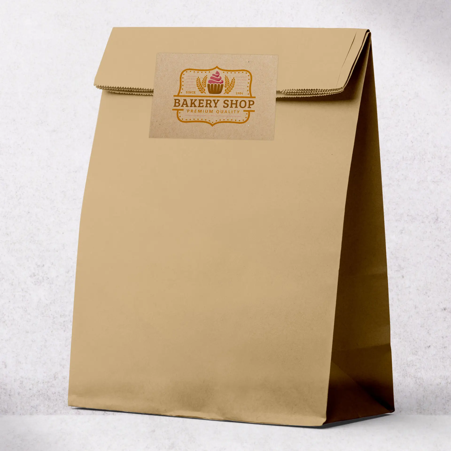 Brown matte kraft paper bag with a logo label reading "Bakery Shop" attached to the front.