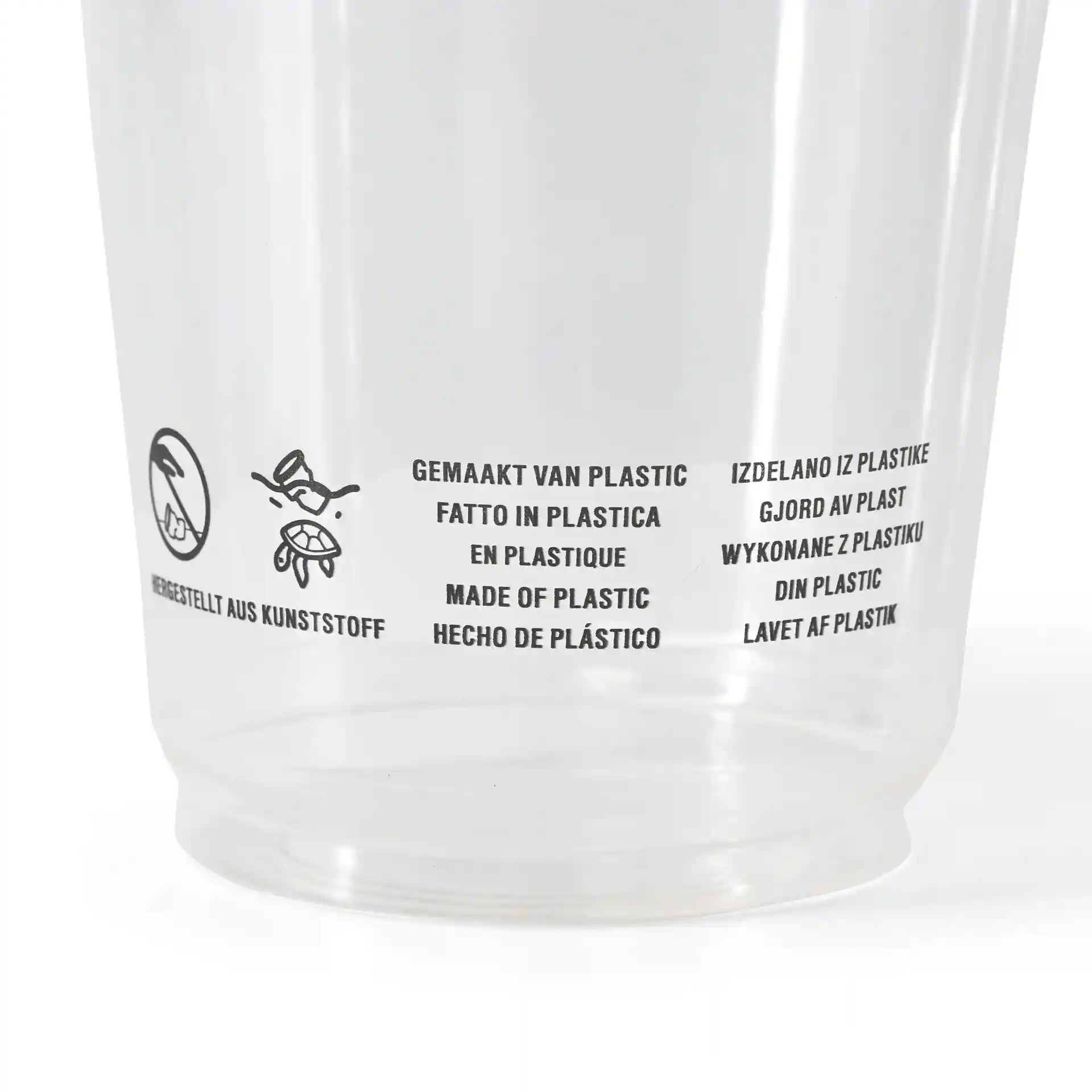 Clear plastic cup with printed multilingual text about material and usage instructions.