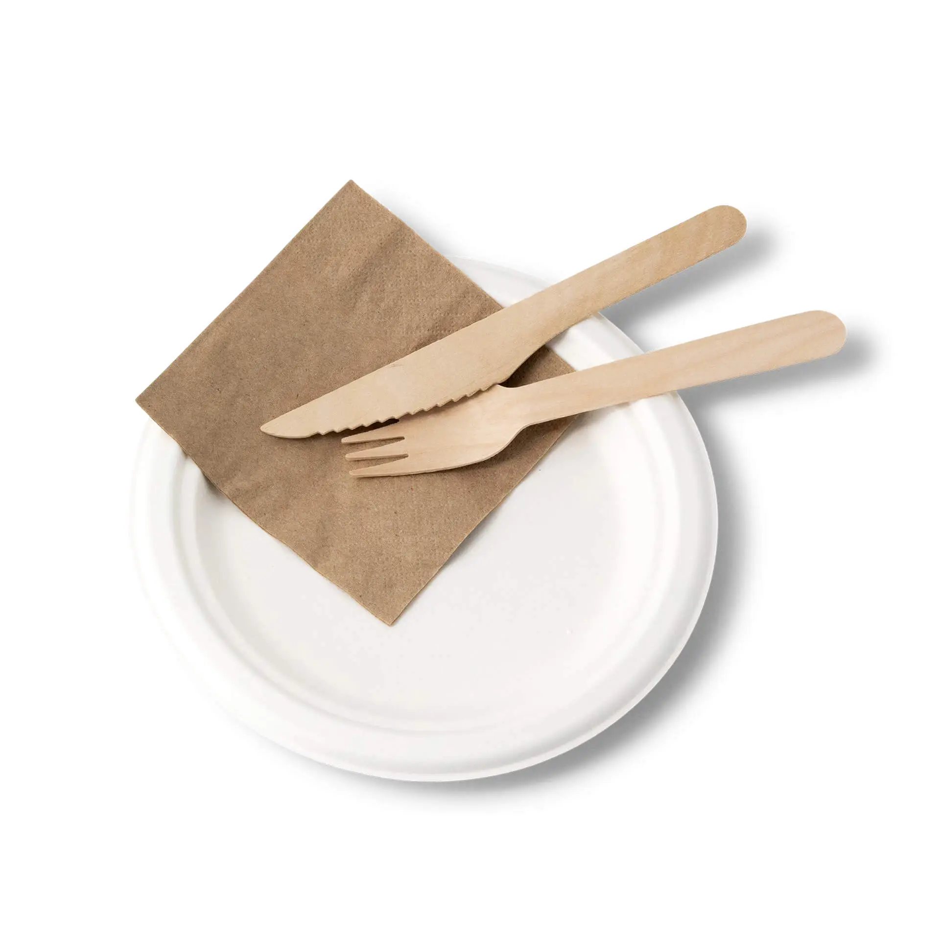 Round disposable sugarcane plate with a brown napkin, wooden fork, and knife on top.