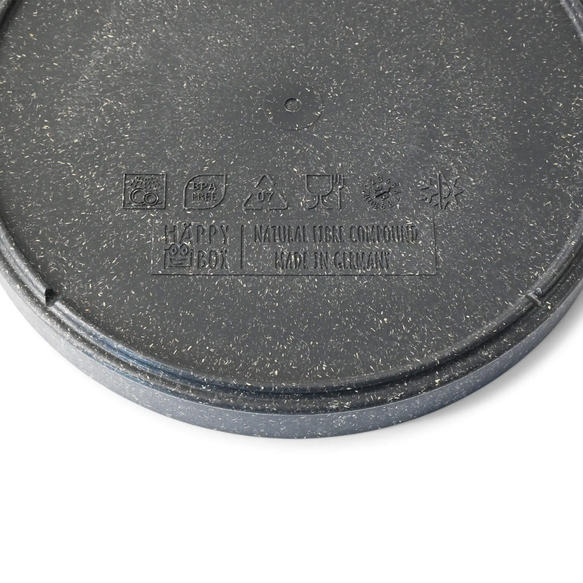 Round grey plate made of bio compound, showing a textured surface and various symbols on the bottom.
