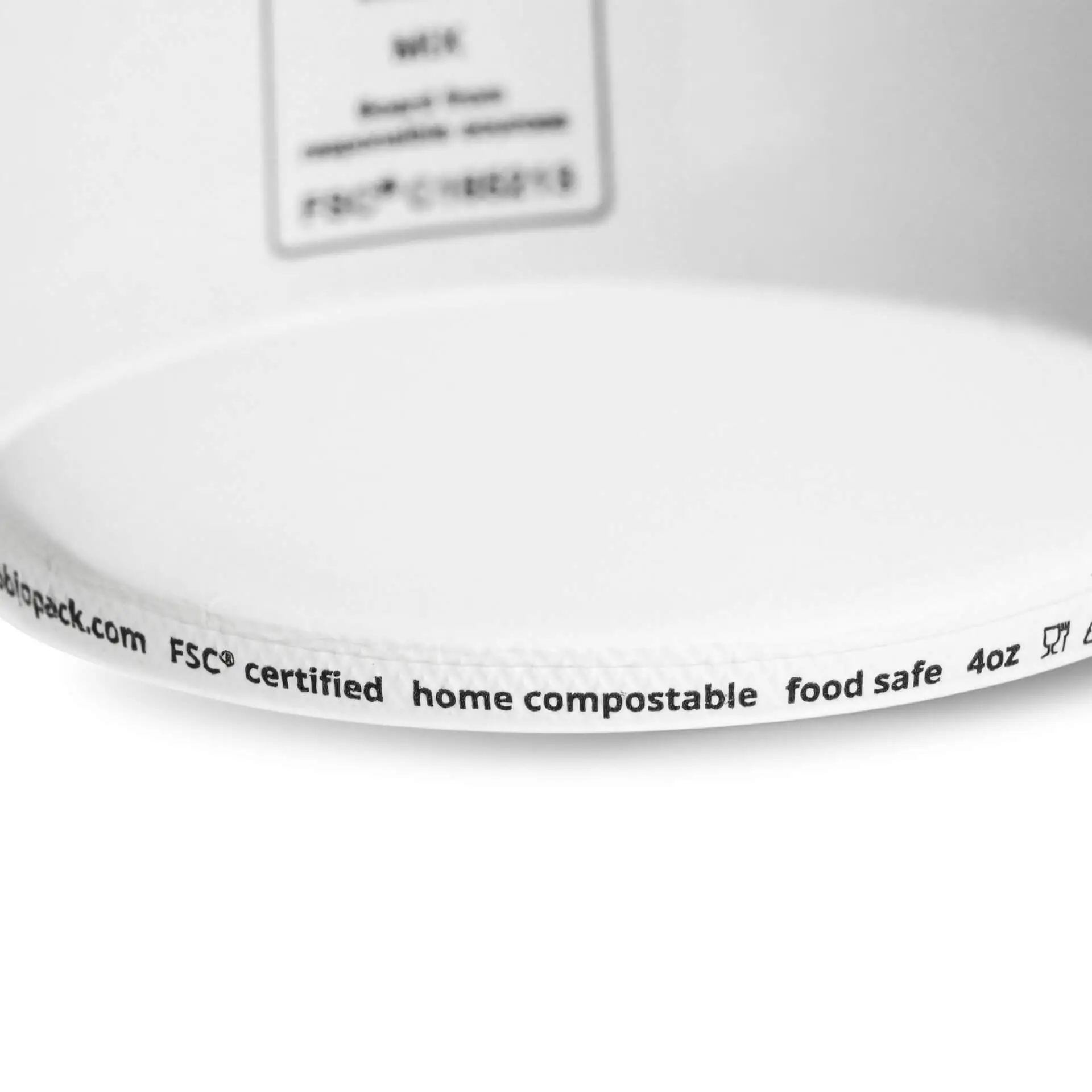 White 4 oz ice cream cup featuring a PE coating; markings indicate food safe and home compostable features.