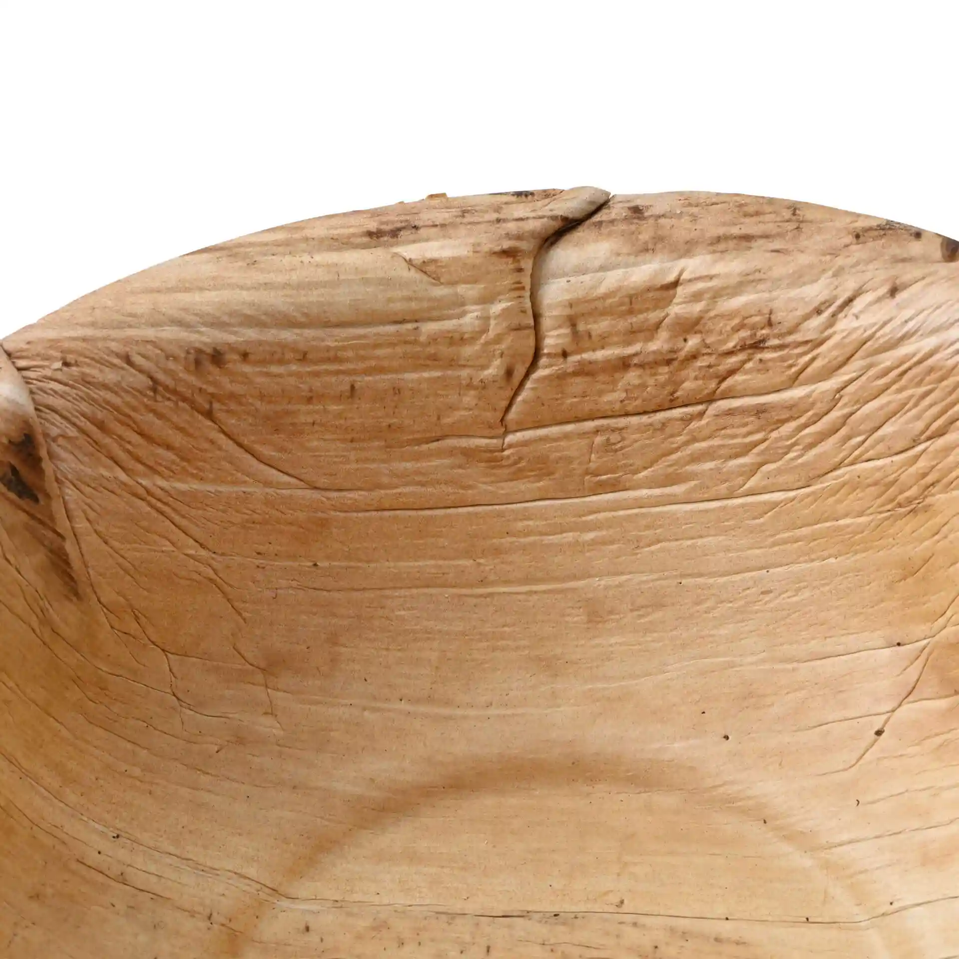 Close-up of a round palm leaf bowl with a grain texture, showing the interior and natural markings.
