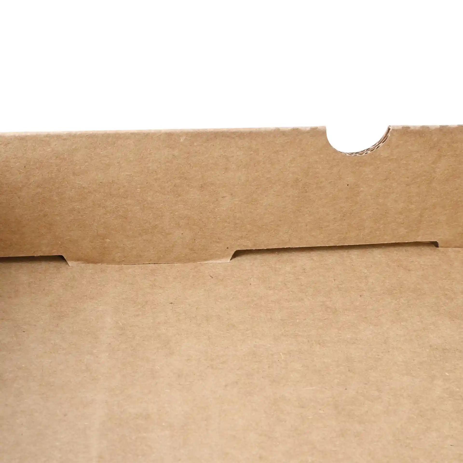 Close-up of a brown cardboard pizza box with a flap and cut-out tab, showing the interior surface.