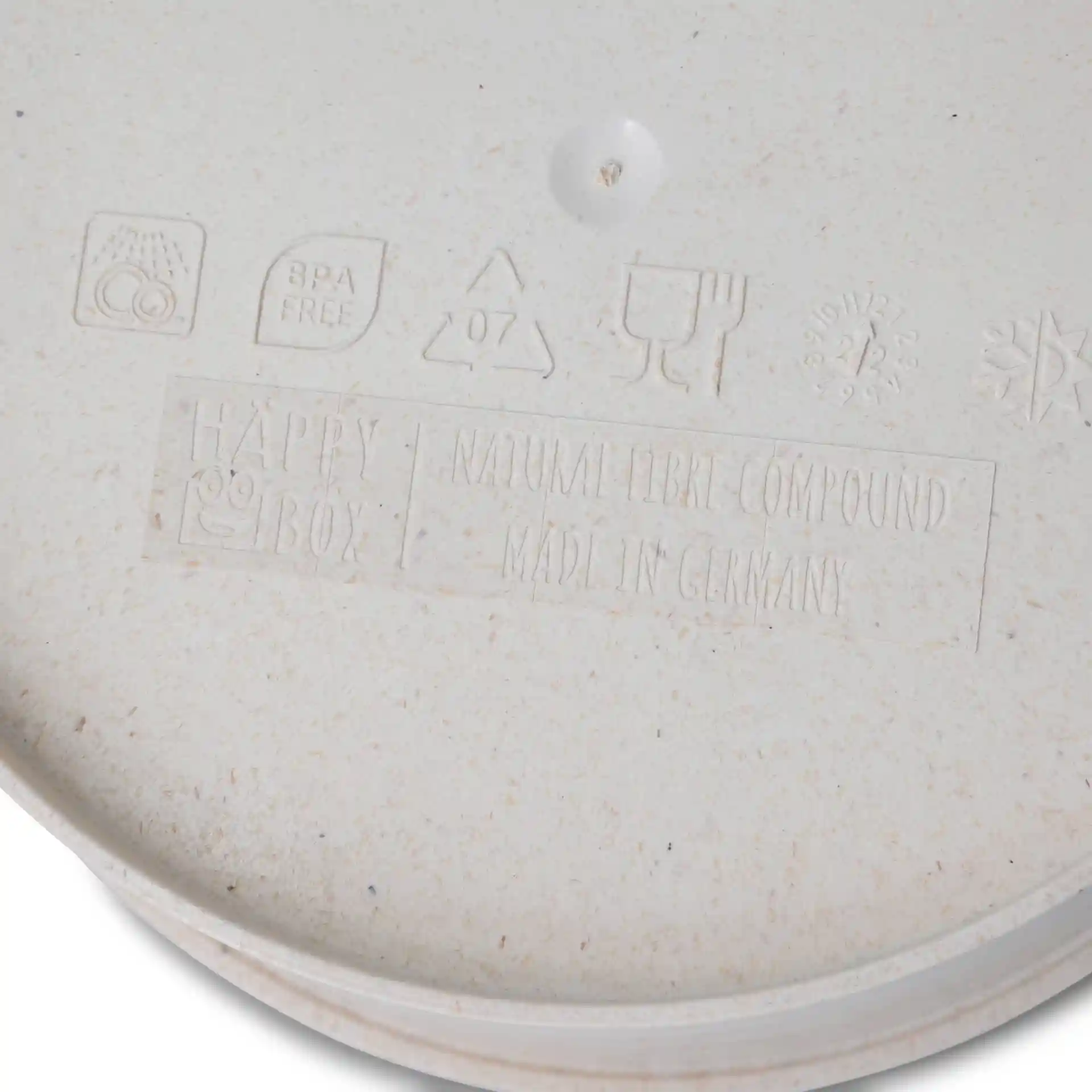 Round reusable bowl in creamy white, made from bio compound, with embossed markings on the base.