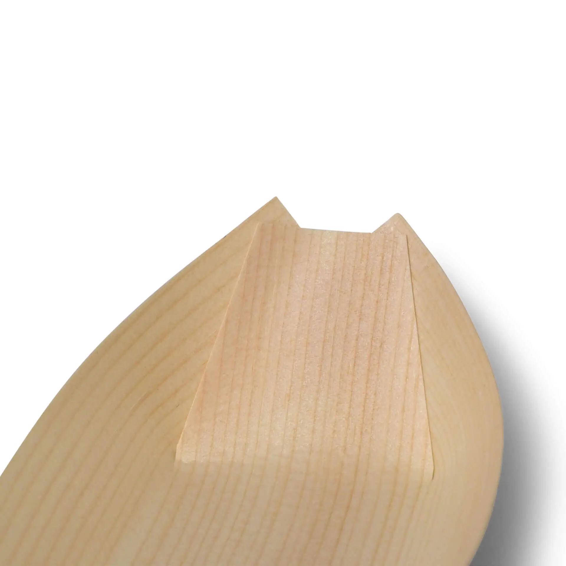 Close-up of the tip of a wooden boat-shaped item with a flat end and smooth surface.