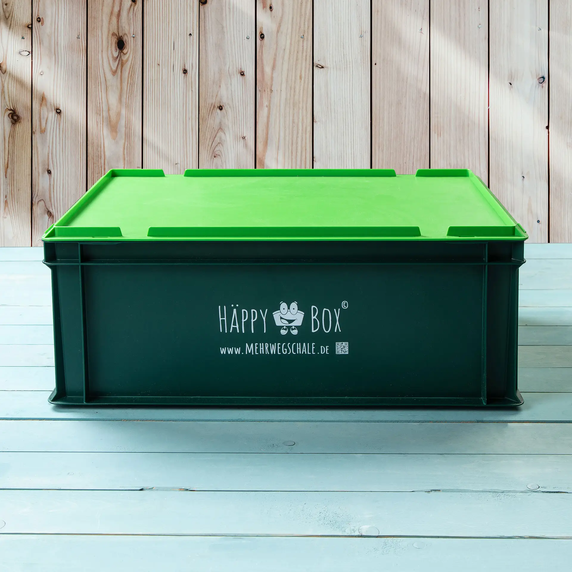 One green reusable storage box with a lid, featuring the label "HAPPY Box" on the side.