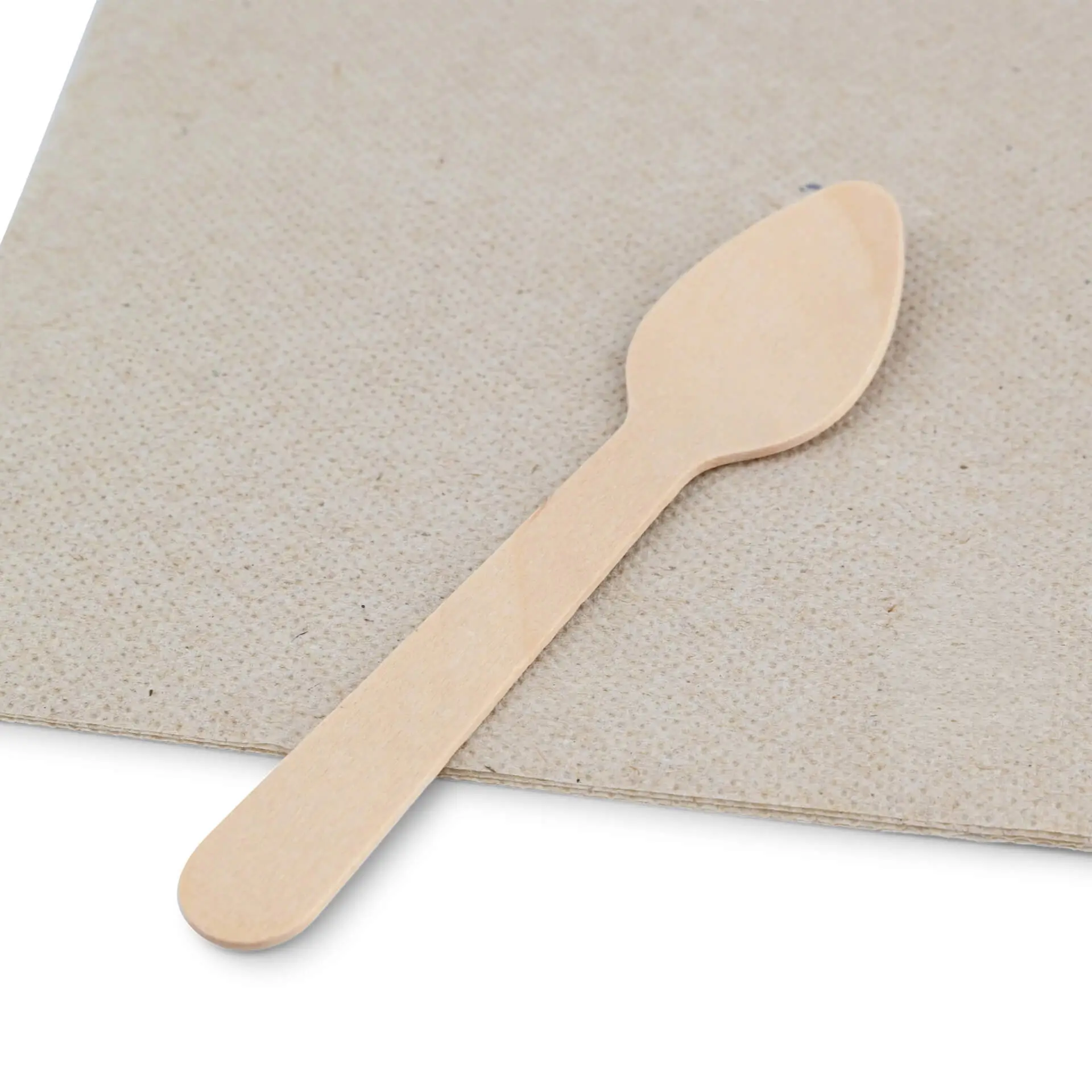 Wooden espresso spoon, 11 cm long, placed on a textured brown surface with a recycling symbol nearby.