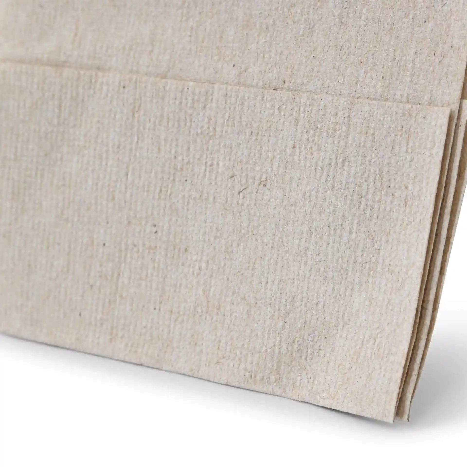 Close-up of unbleached rPaper napkin with a black recycling symbol and text indicating it is 100% recycled.