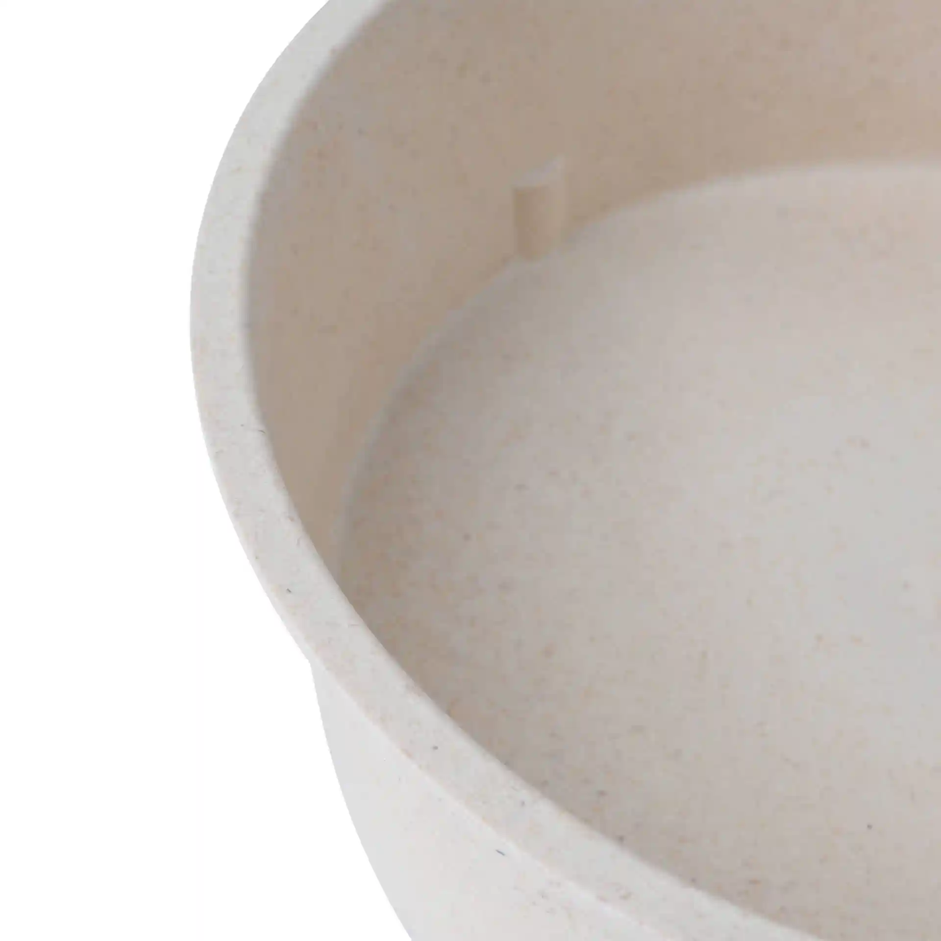Close-up of a round reusable bowl in cream white, showing the interior and a small protrusion.