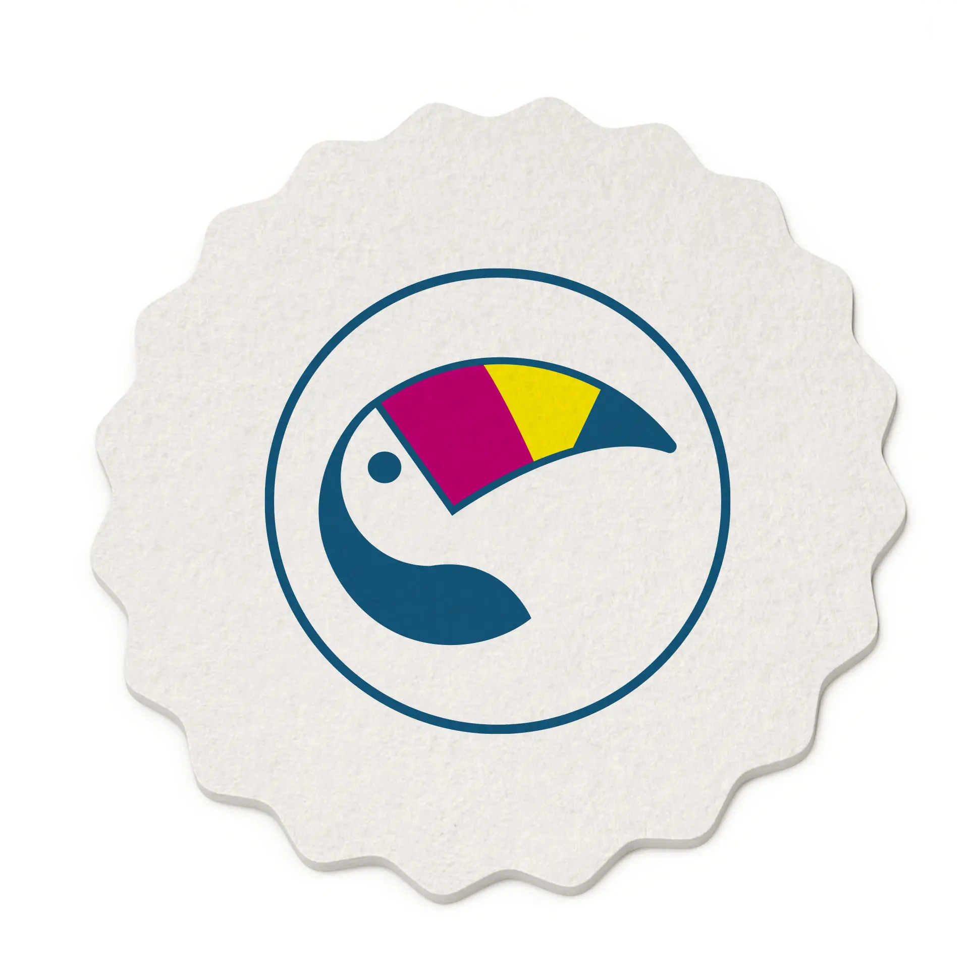 Printed beer coaster in bottle cap shape with a colorful toucan design on a white background.