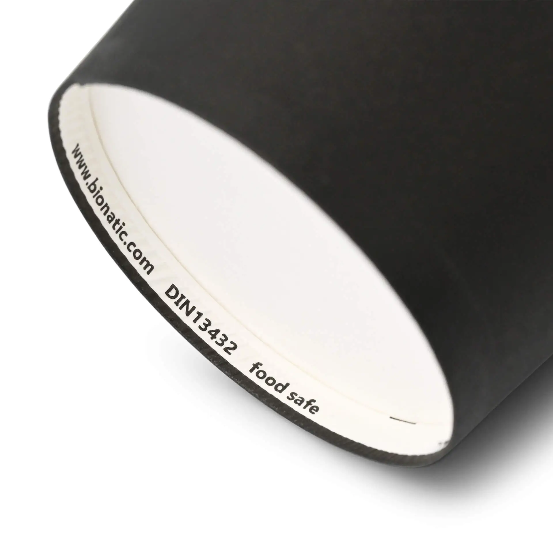 Black cardboard cup with a white interior, showing a label with markings on the bottom edge.