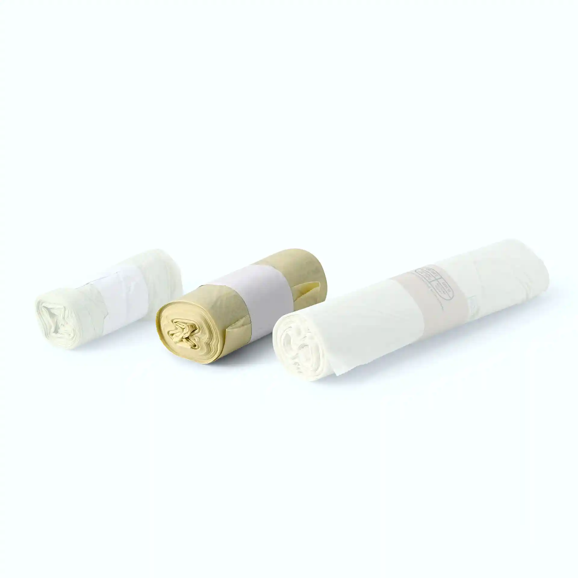 Three rolls of transparent bio bin bags, each wrapped with a label, displayed on a plain background.