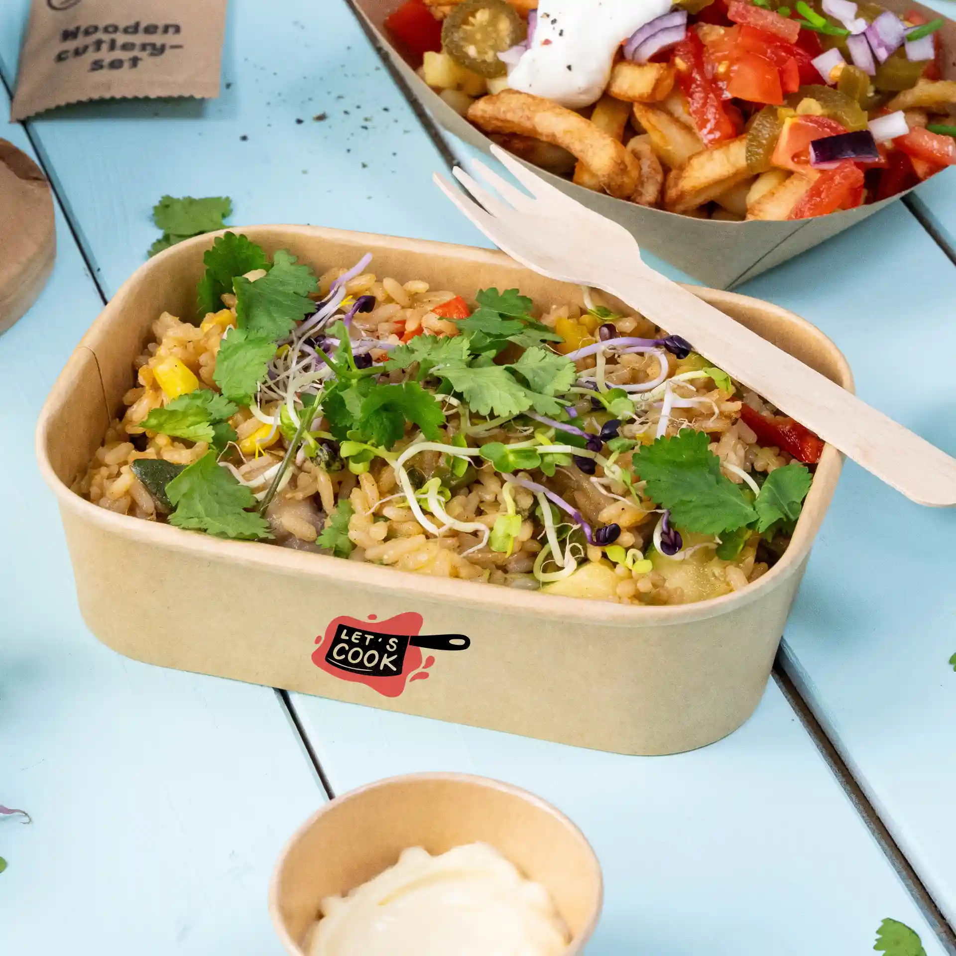 Rectangular brown salad bowl with rice, topped with cilantro and sprouts, and a wooden fork beside it.