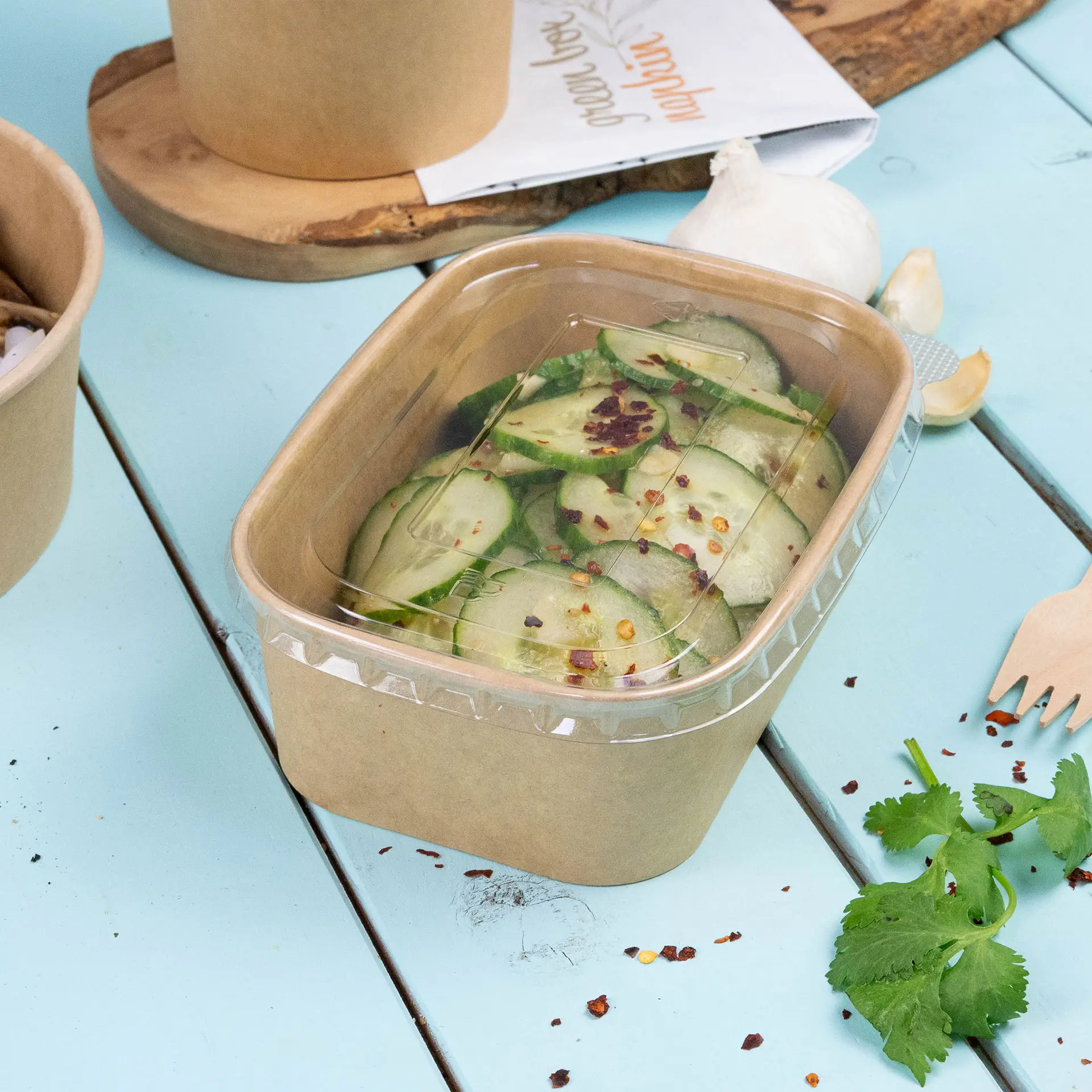 Transparent rectangular lid made from recycled PET for food containers; features symbol for food safety.