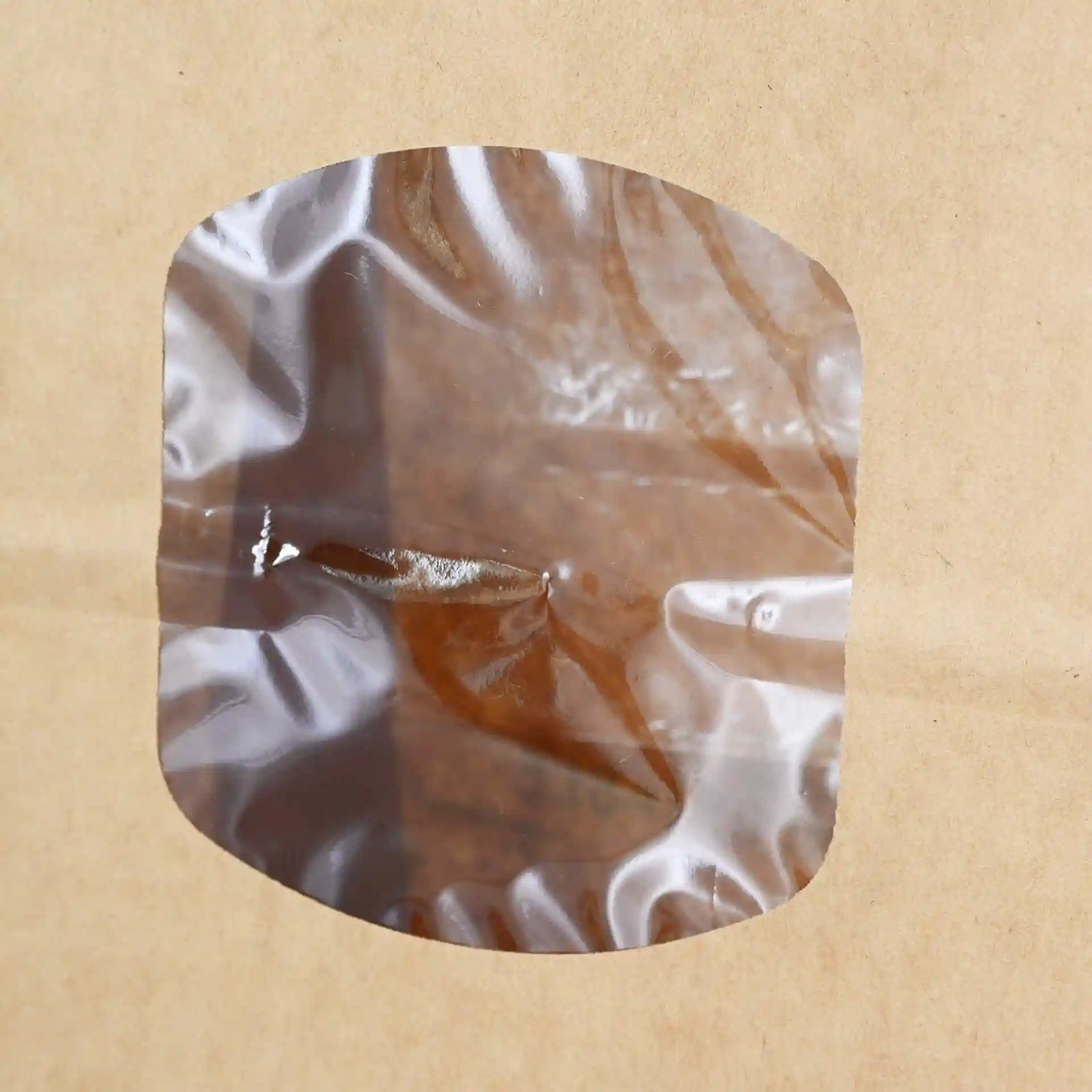 Transparent window on a brown kraft paper bag, showing the contents inside.
