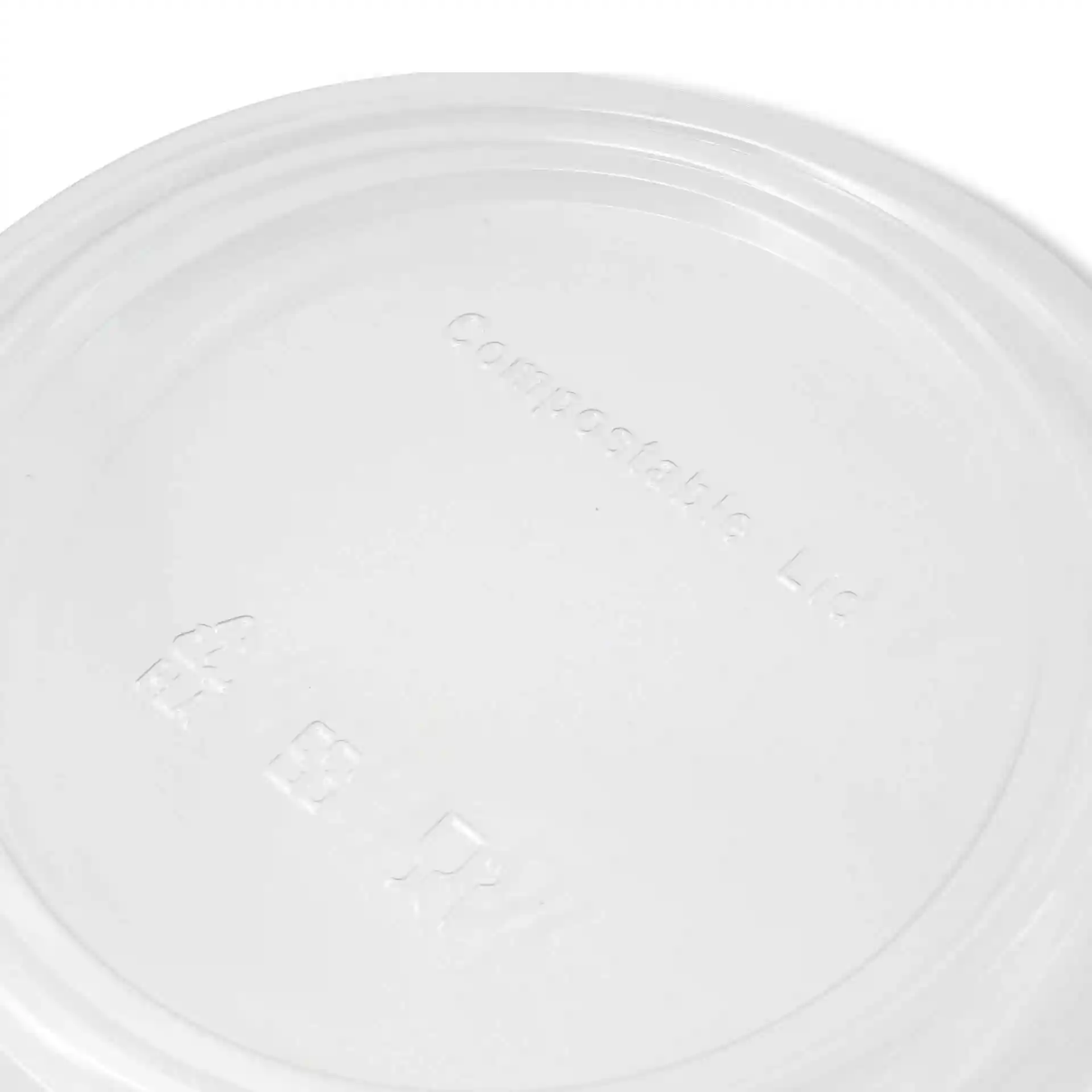 Transparent round cup lid made of PLA, showing embossed markings on the surface.