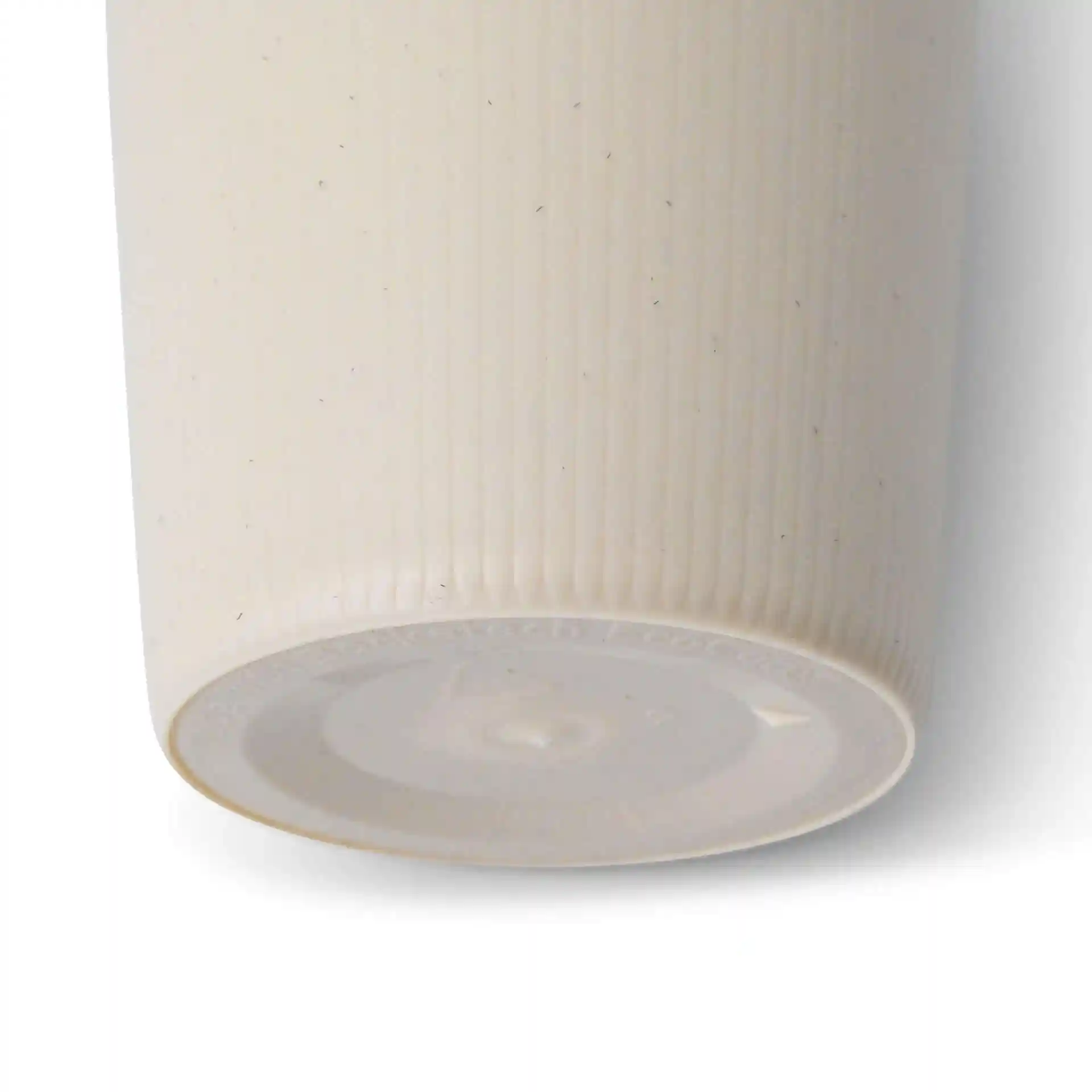 Cream white reusable coffee cup with ribbed texture, showing the bottom and part of the side.