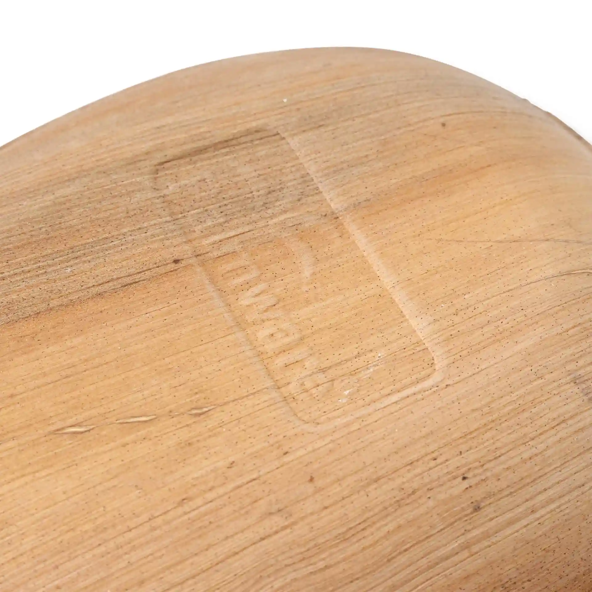 Close-up of a palm leaf plate showing a light wood grain texture and an embossed logo on the surface.