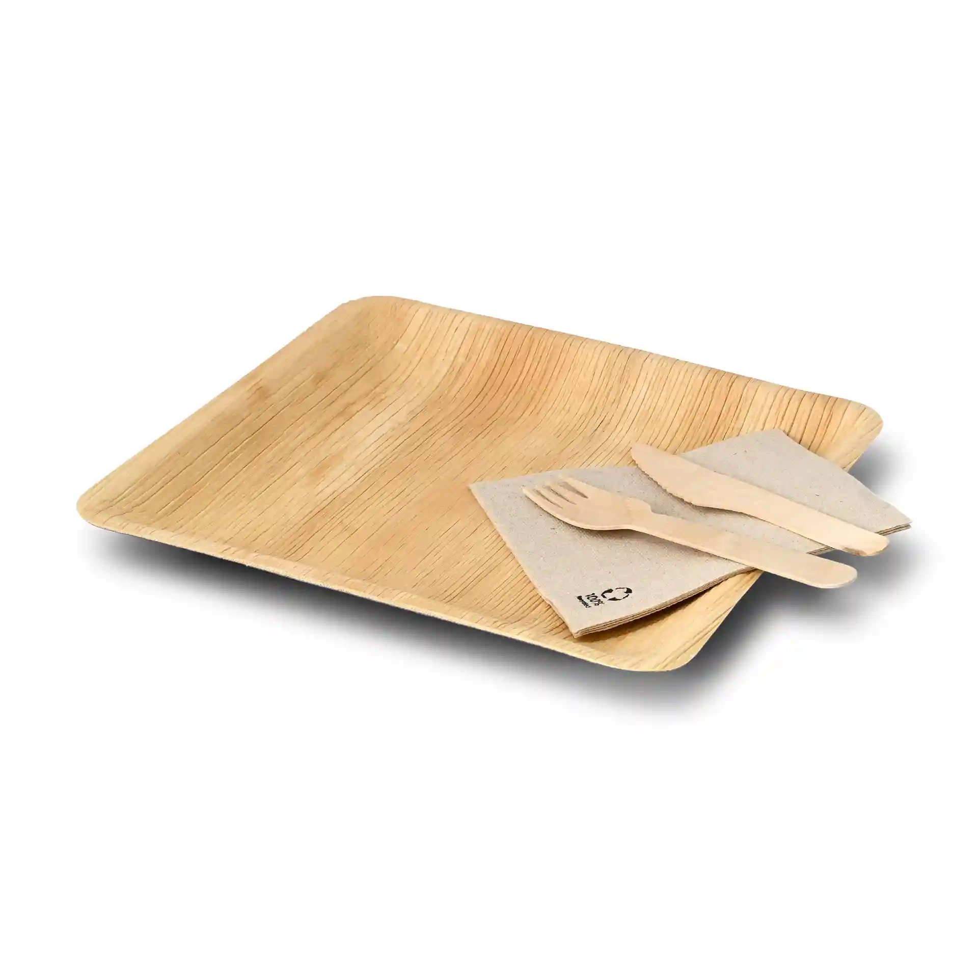 Square palm leaf plate with a grain texture, accompanied by a napkin and wooden cutlery.