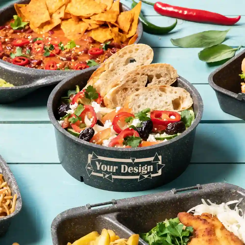 Black serving bowl with salad, topped with red peppers, olives, and bread; includes a customizable label.