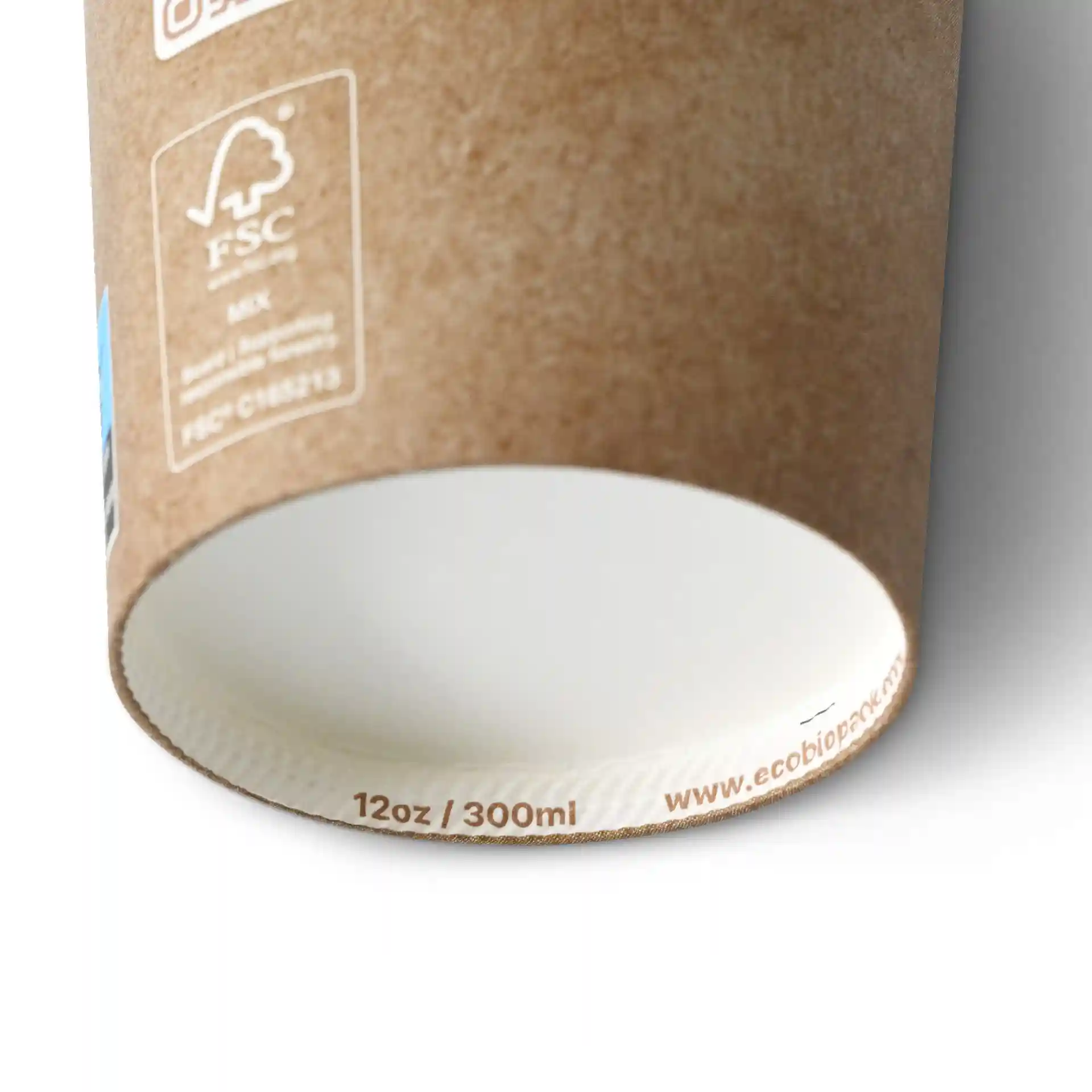 Brown paper cup with a white inner lining, 12 oz capacity, showing the bottom edge and markings.