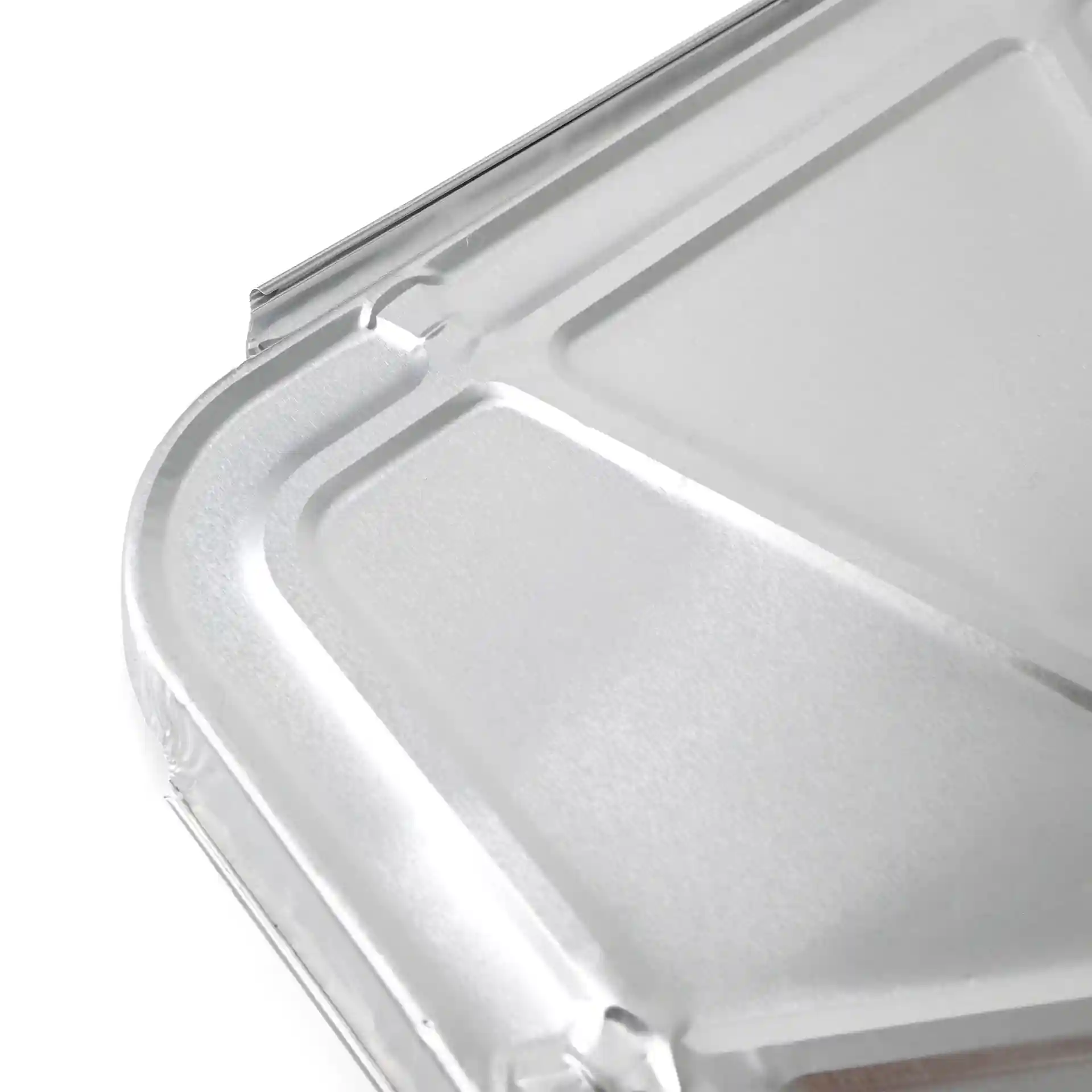 Aluminium lid for a rectangular two-compartment meal tray, showing a close-up view of the surface and edges.