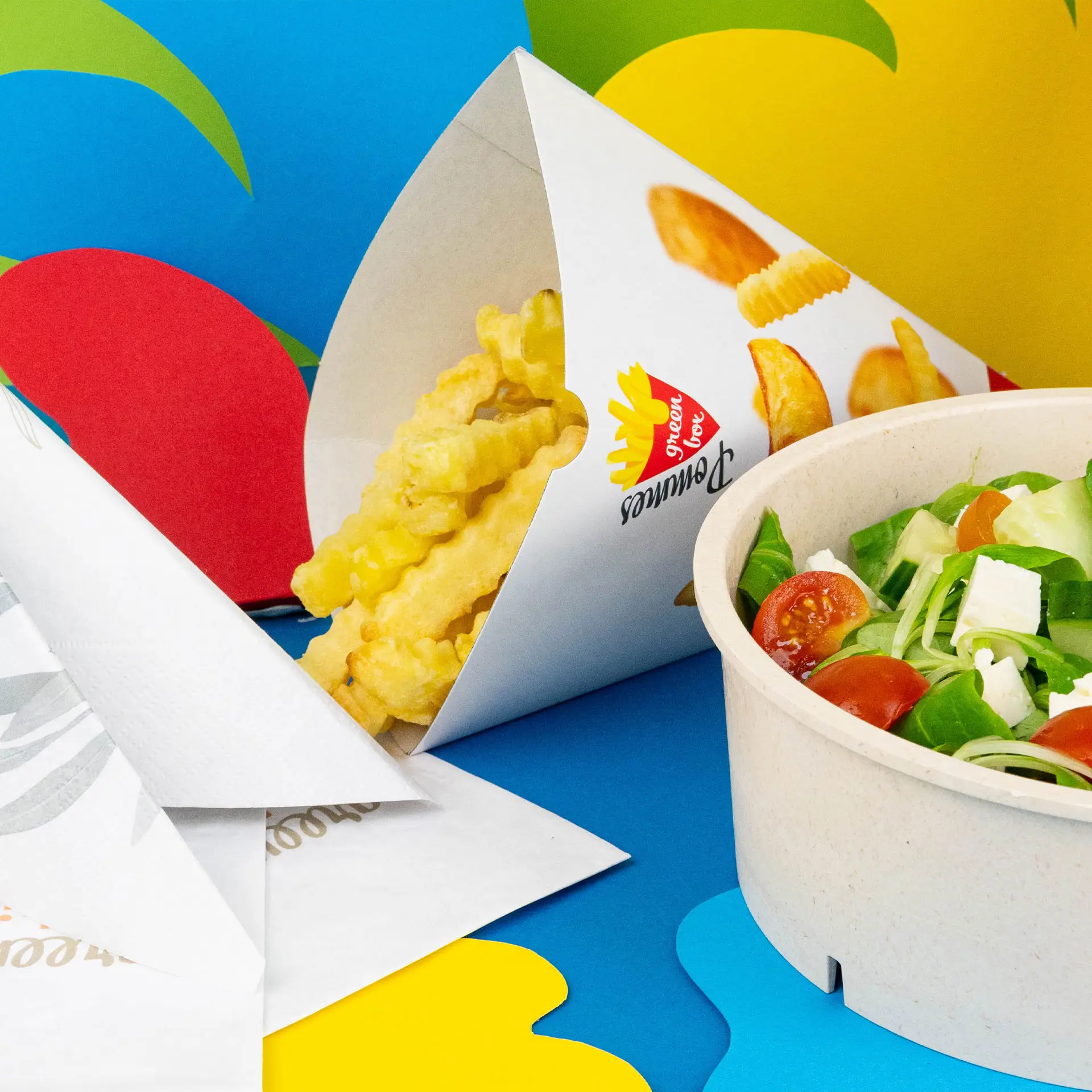Image of a printed white french fry cone with crinkle-cut fries and a salad in a bowl on a colorful background.