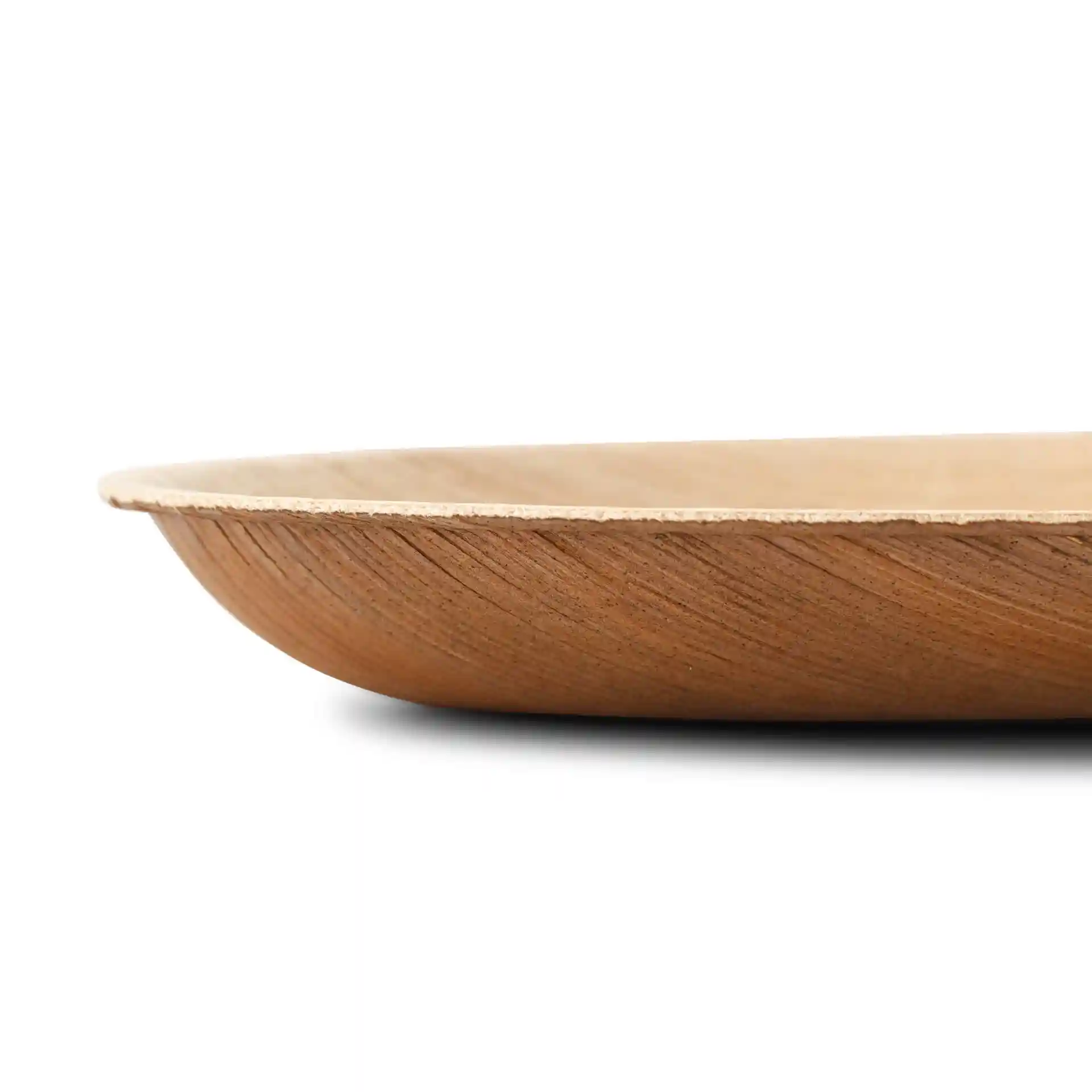 Side view of an oval palm leaf plate with a grain texture, showing a shallow design and no coating.